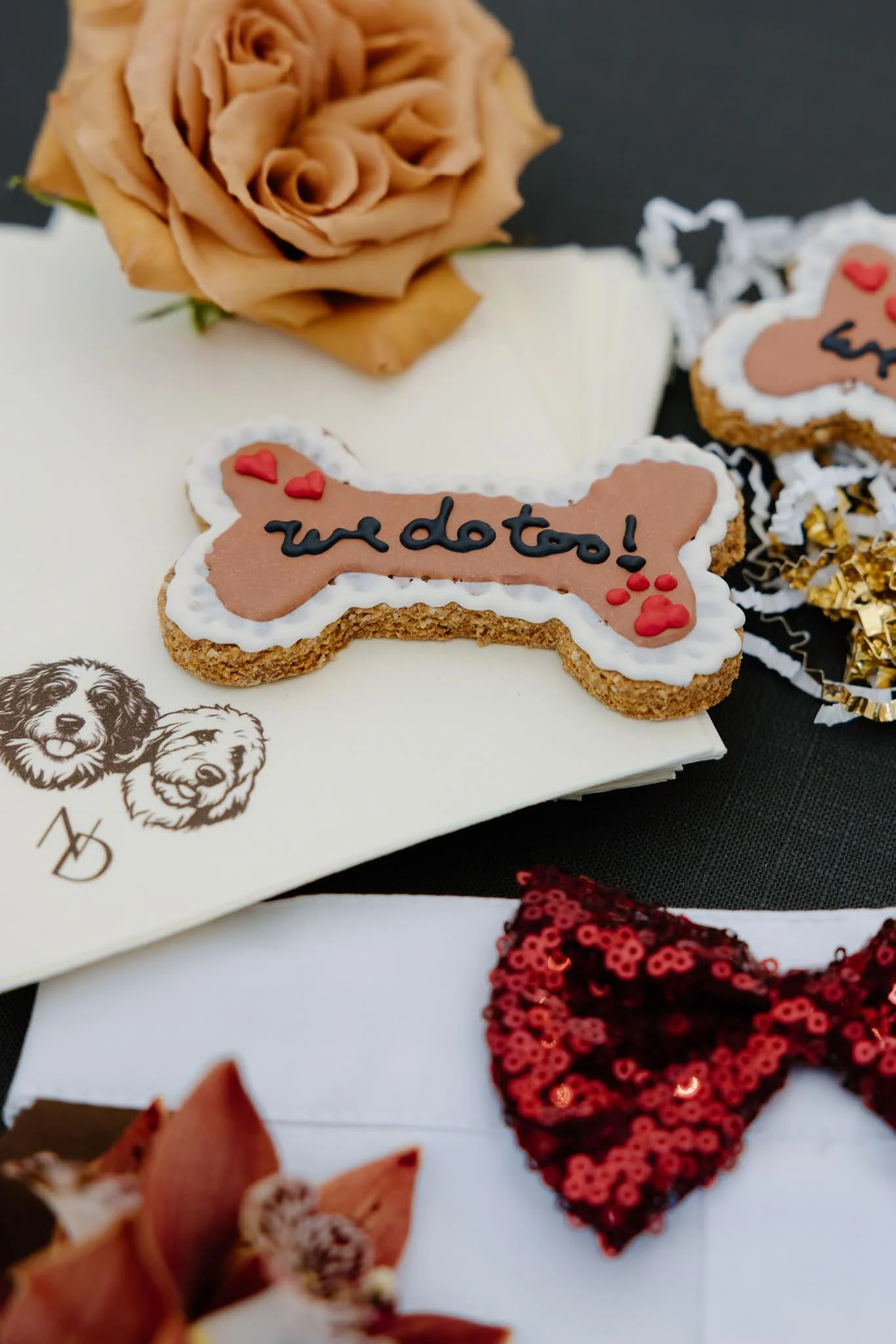Dog inclusive wedding flat lay including dog face on napkin and dog wedding treat. 