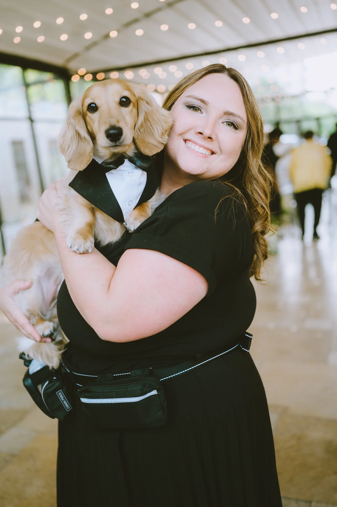 Wags of Love holding dog in tuxedo at wedding in Chicago at the Galleria Marchetti.  