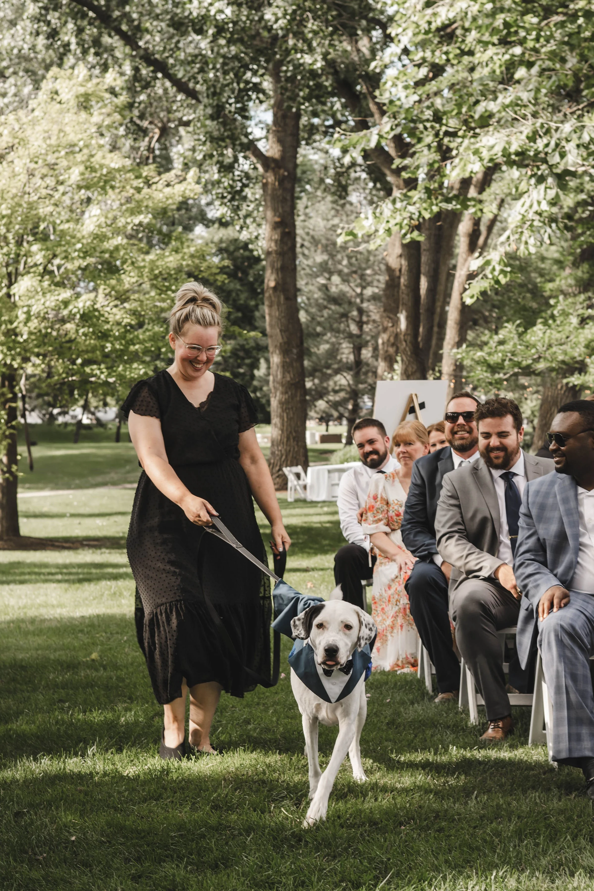 Dog wedding attendant walking couple’s dog down wedding aisle at Abbey Resort in Lake Geneva Wisconsin.
