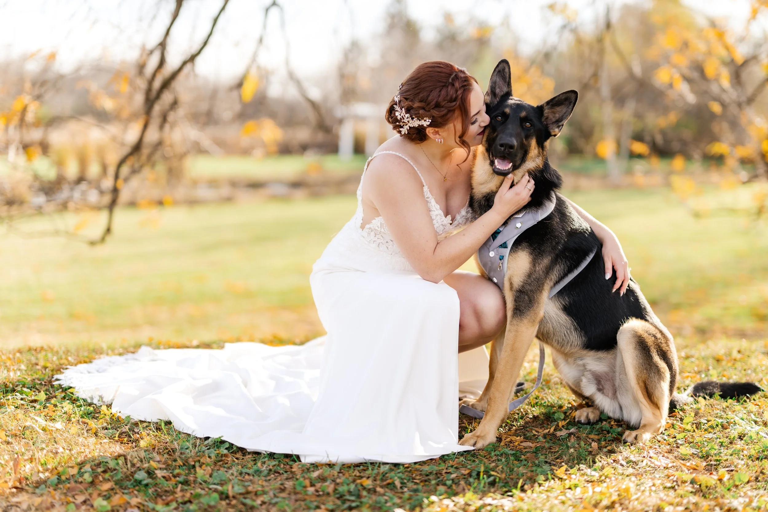 Wedding day photo of Bride with their dog with professional pet wedding attendant.