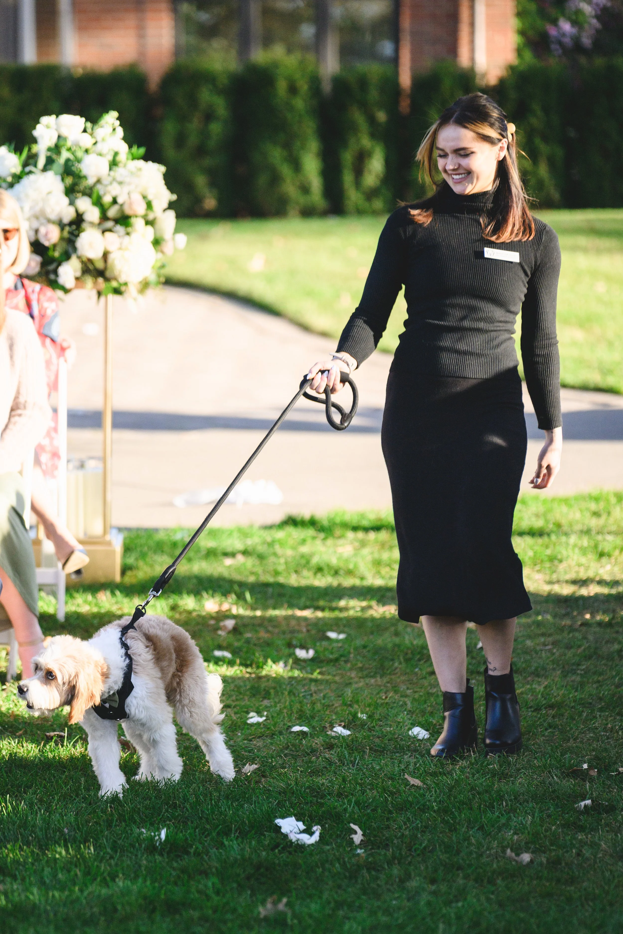 Professional pet wedding attendant Wags of Love walking dog down aisle at ceremony.