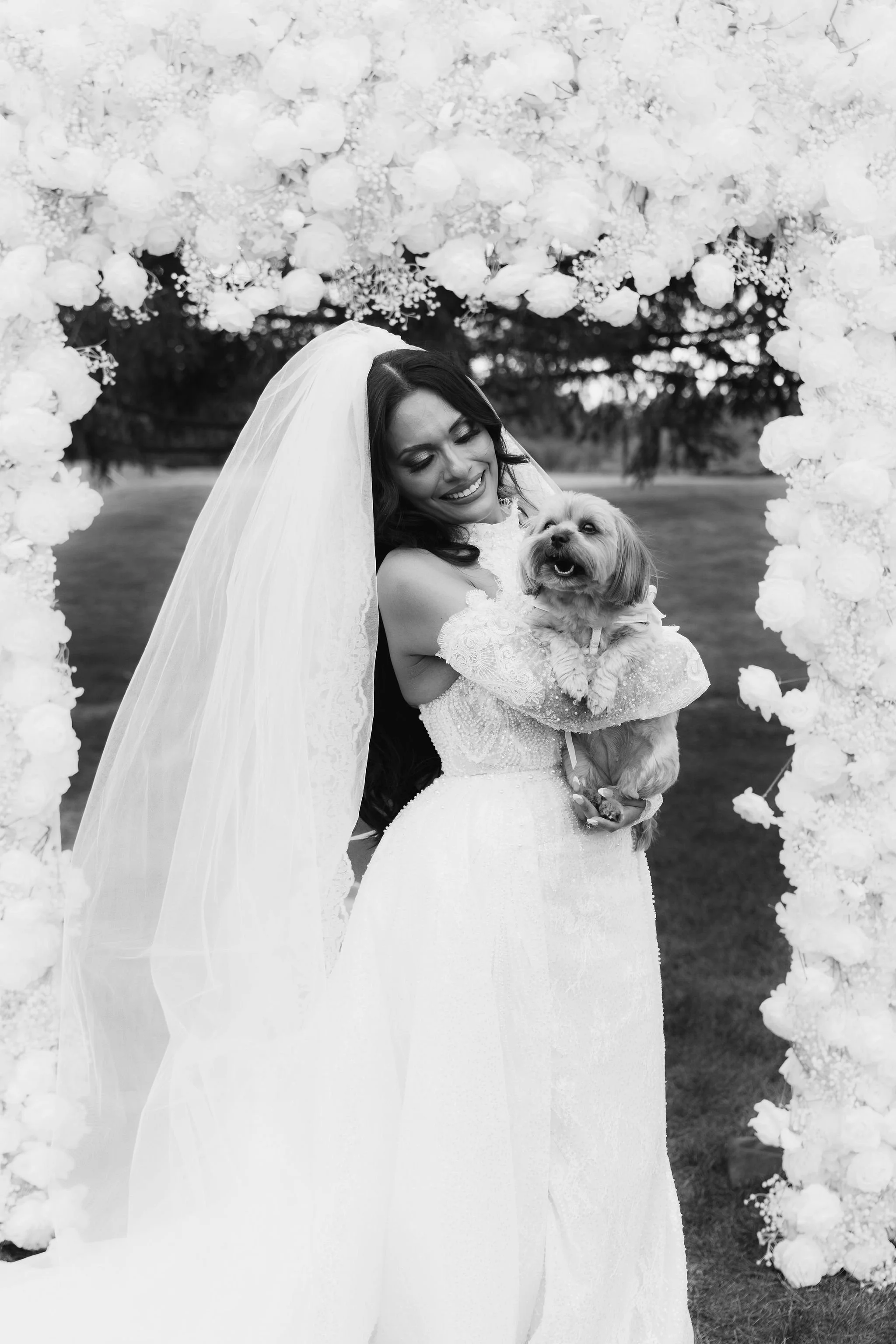 Bride hugging her dog during wedding in Chicago with professional dog handler.