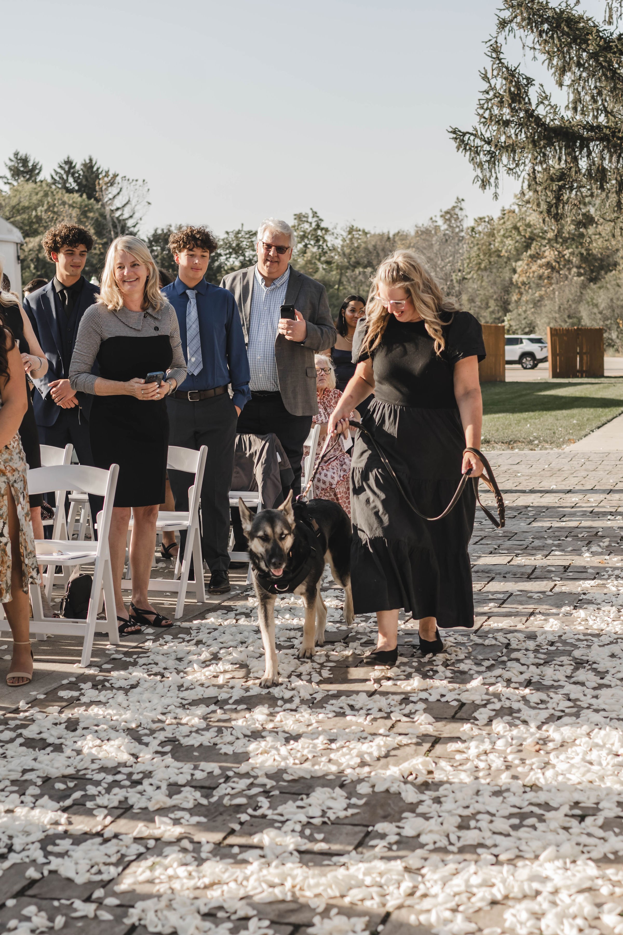 Professional pet wedding attendant Wags of Love walking dog down aisle at ceremony.