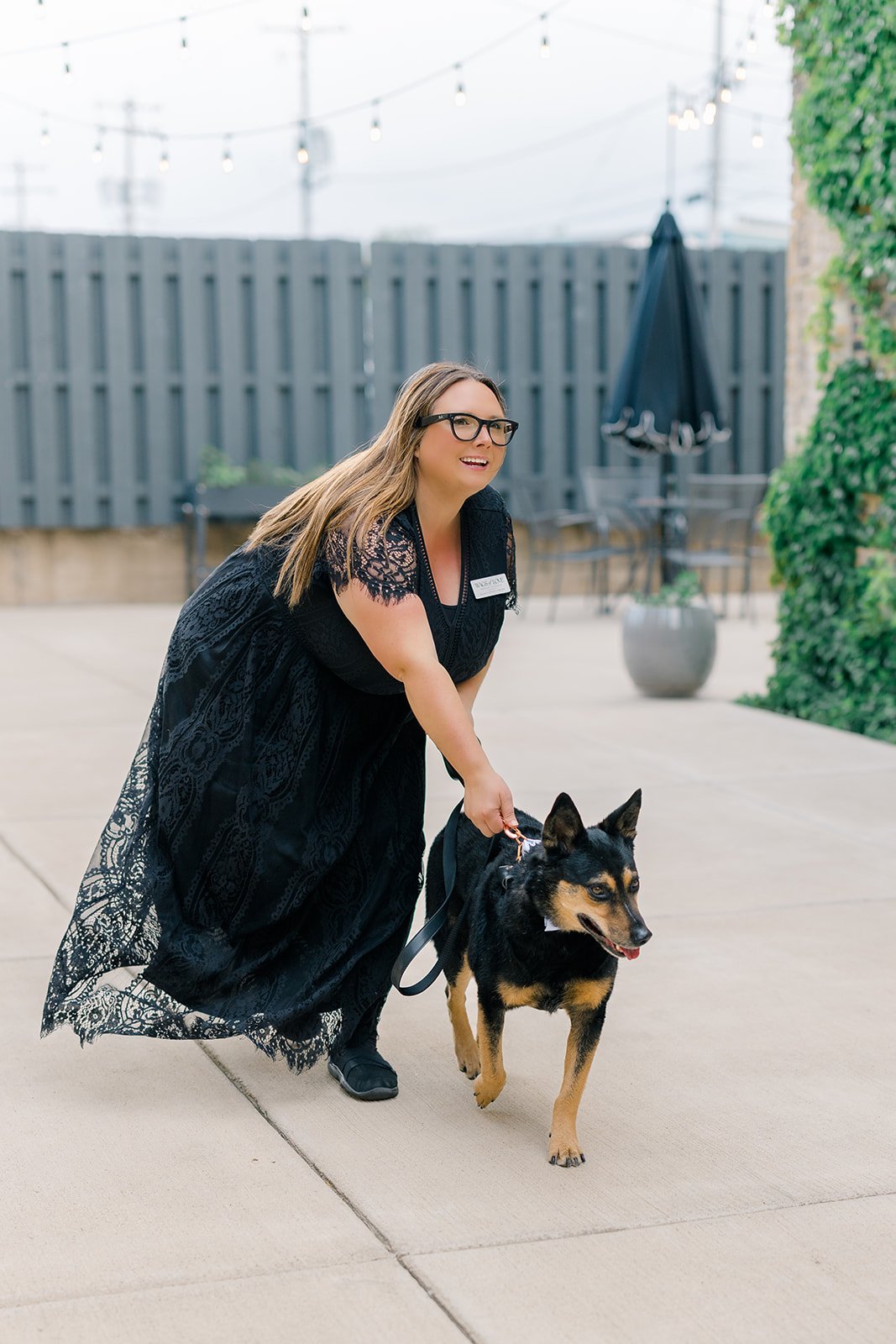 Dog wedding attendant walking couple’s dog down wedding aisle at Mercantile Hall in Burlington Wicsonsin. 