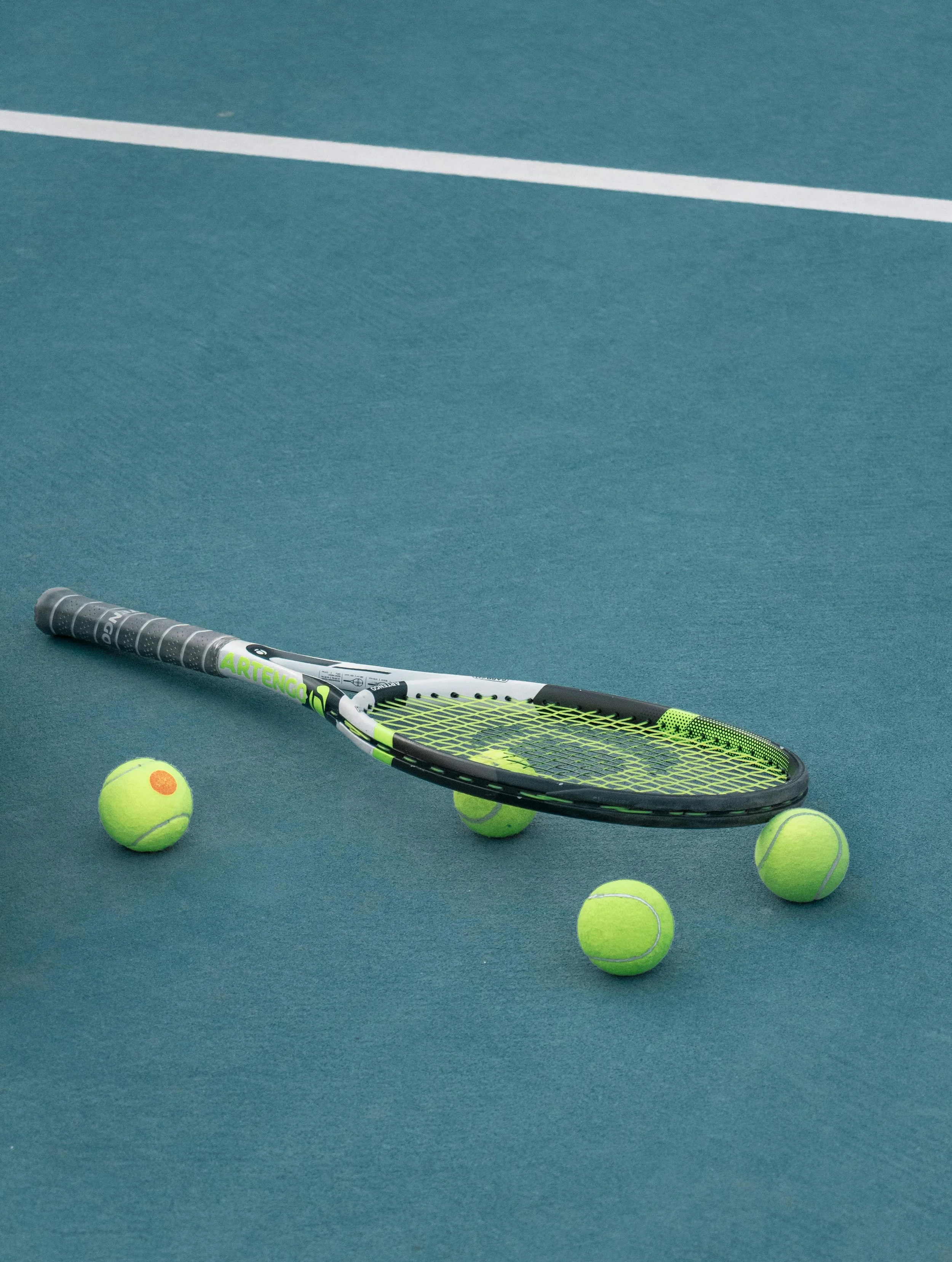tennis racket and ball on court.jpg
