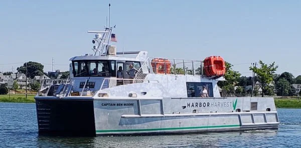 Harbor Harvest catamaran ferry Captain Ben Moore cruising on the water