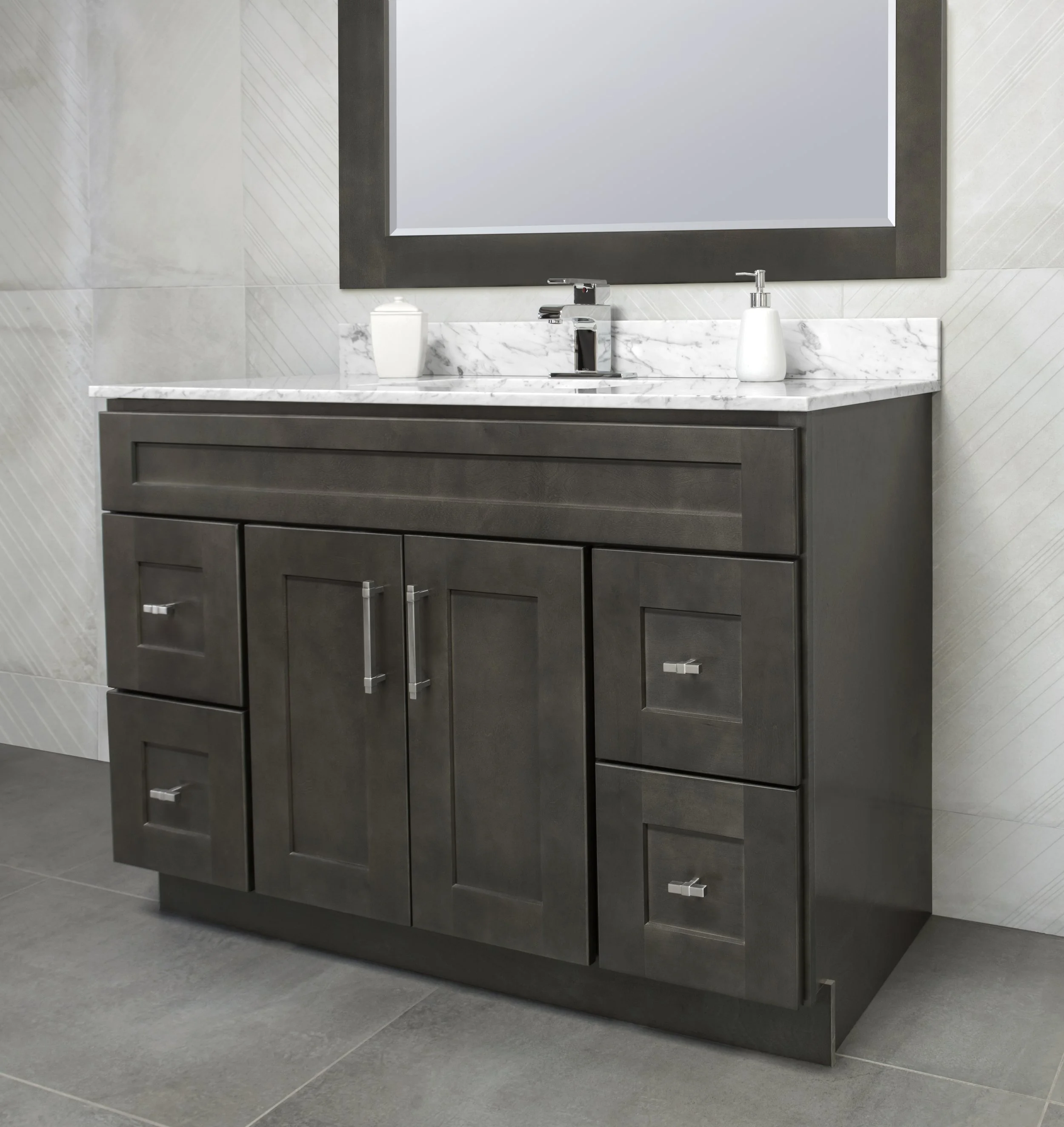 Modern bathroom vanity with a marble countertop, dark wood cabinet, a large mirror with a dark frame, a soap dispenser, a small container, and a faucet.