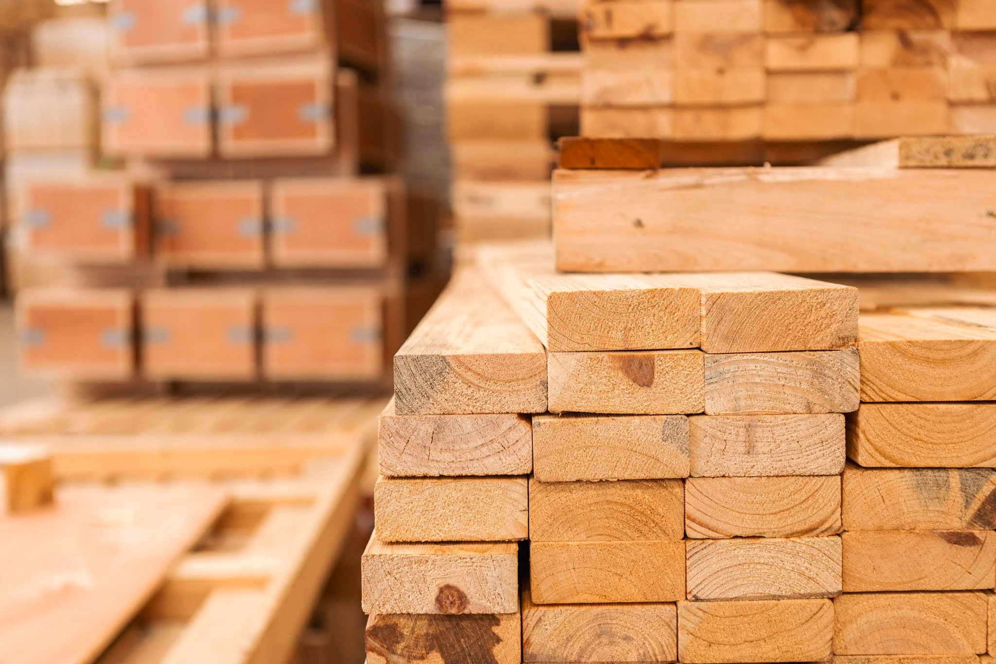 Stacked wooden planks in a woodworking shop.