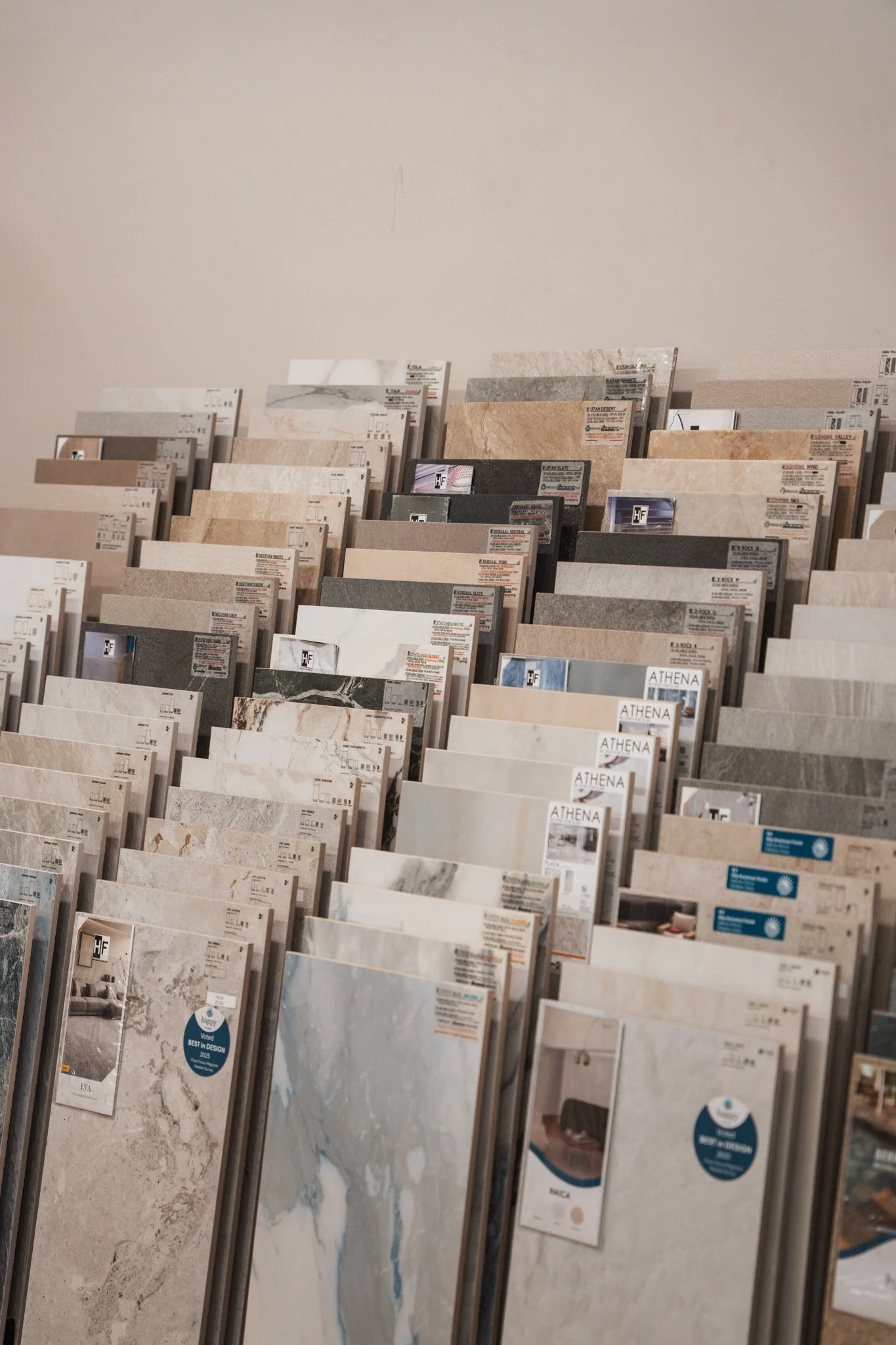 Display of various marble and tile samples arranged in rows.