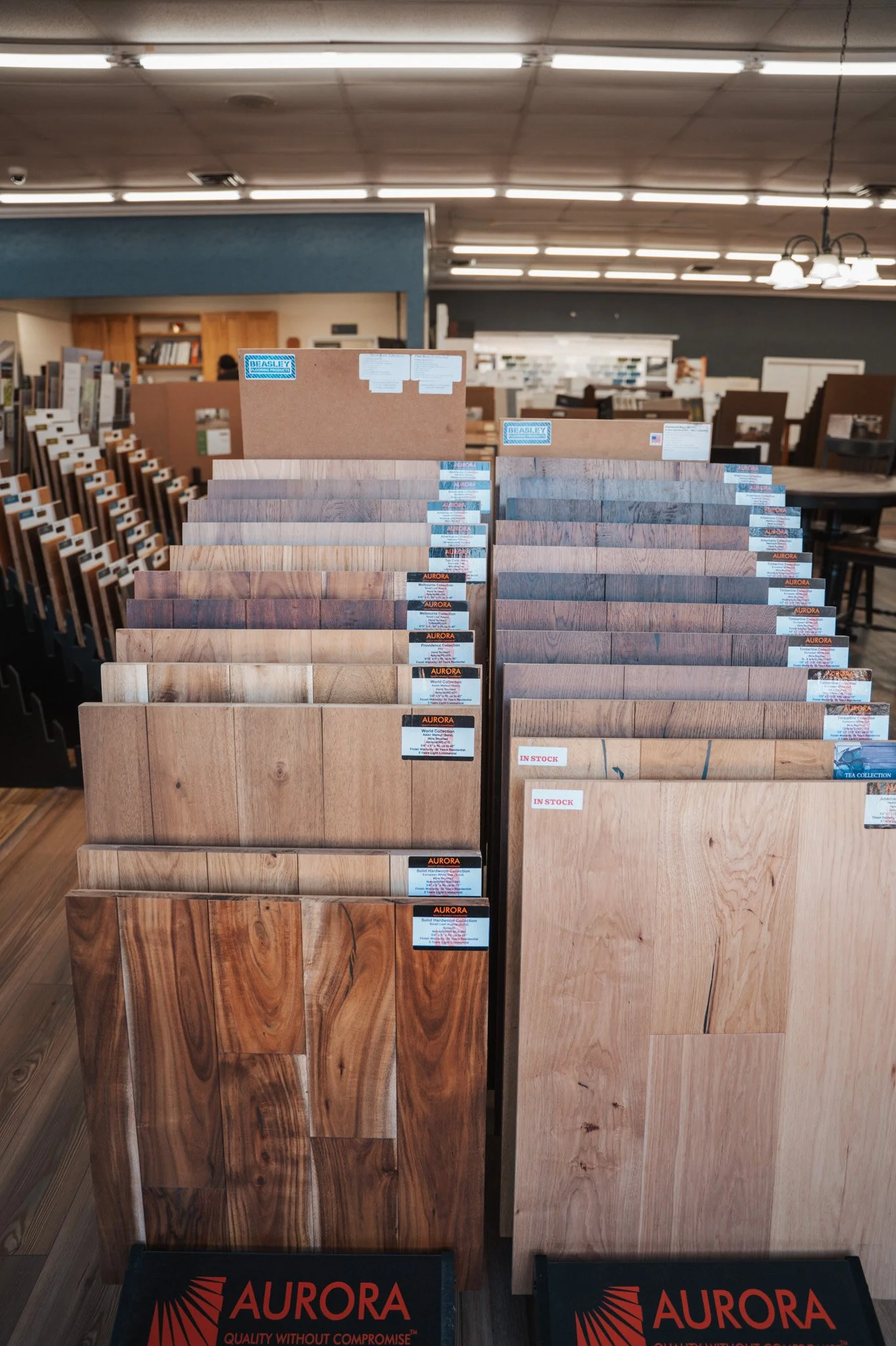 Display of wood flooring samples at Aurora flooring store with various wood grain patterns and colors.