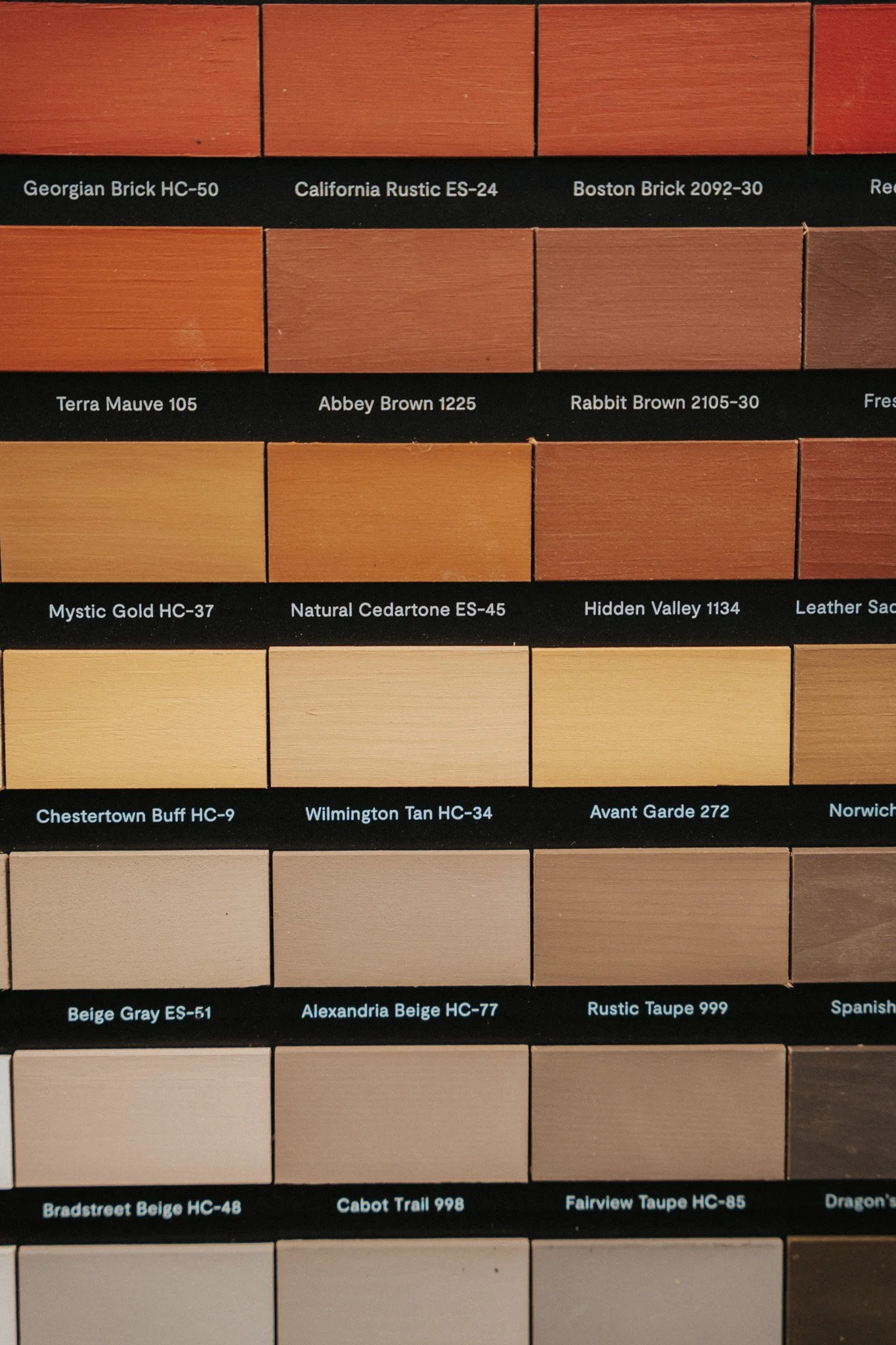 A color swatch chart featuring various shades of brown, tan, beige, and gray, each labeled with a specific name and code, such as Georgian Brick HC-50, California Rustic ES-24, Boston Brick 2092-30, and others.