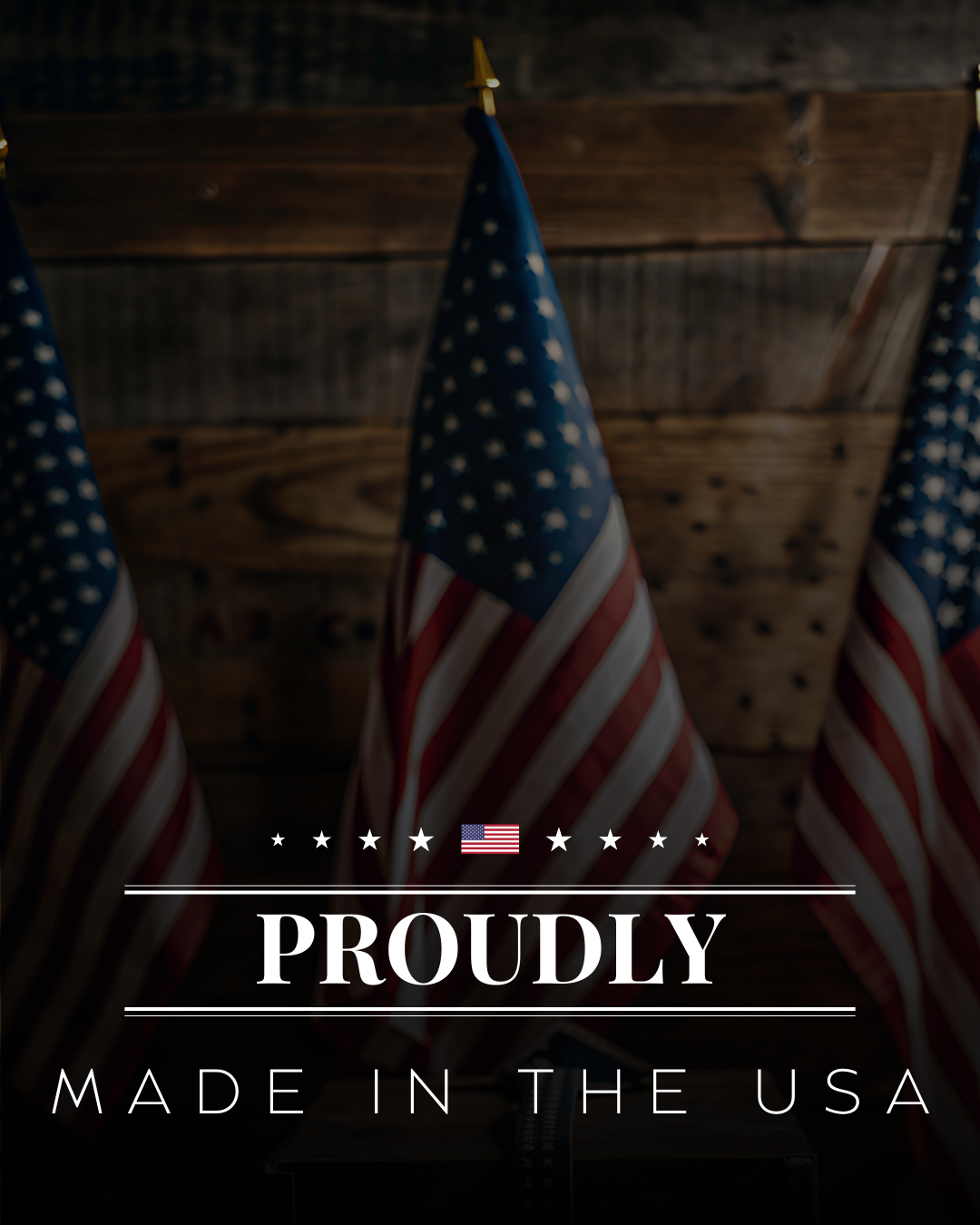 Three American flags hanging in front of a wooden wall with a proudly made in the USA message overlay.