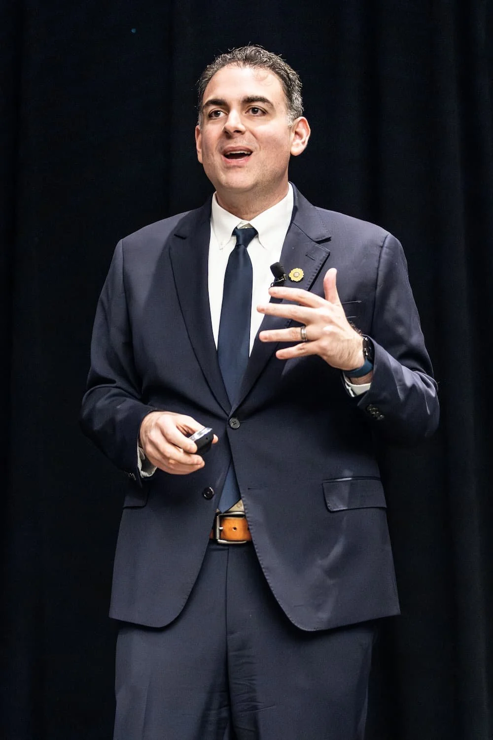 Man is smiling and standing on stage.