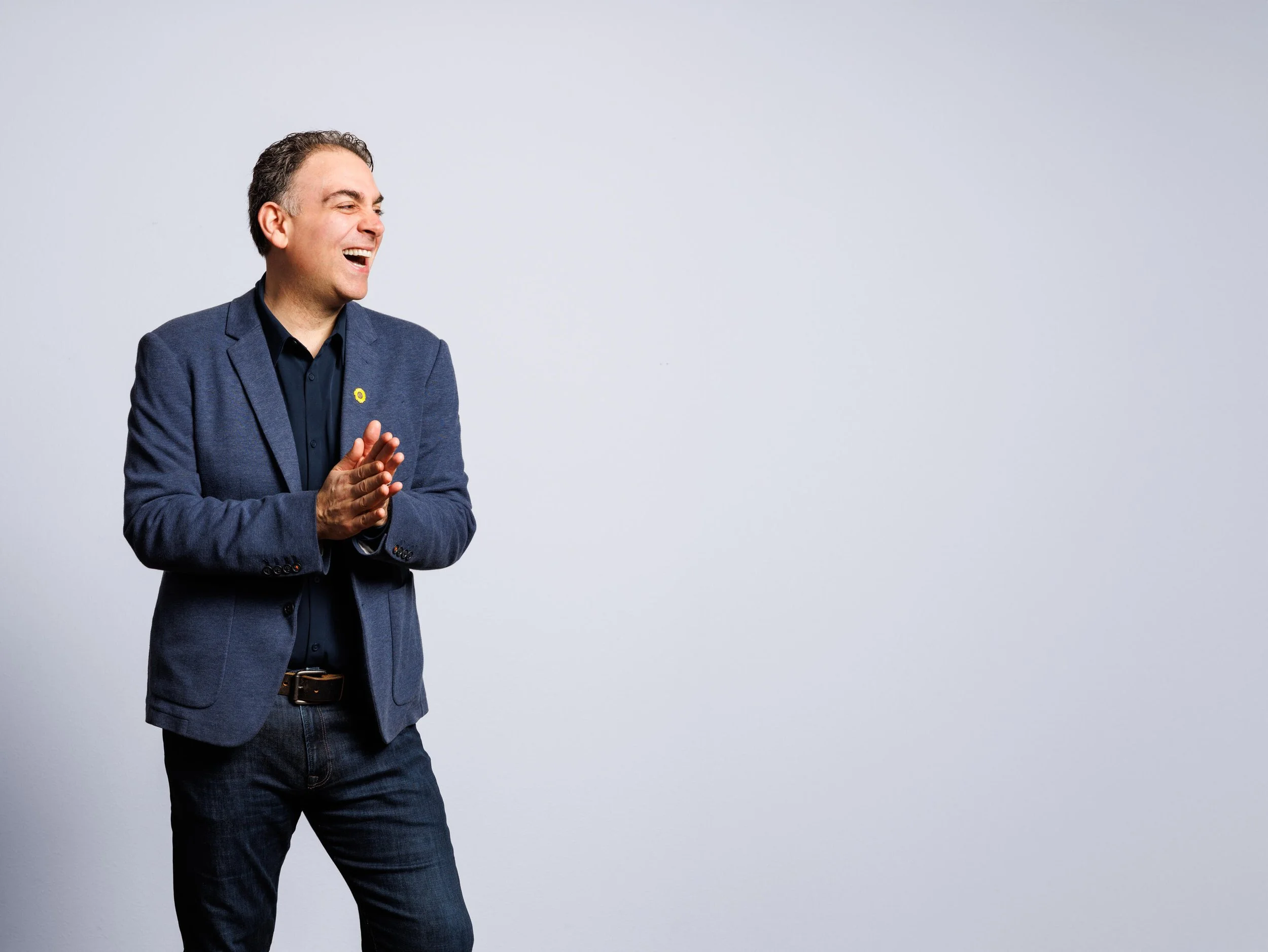 A man smiling to the side.