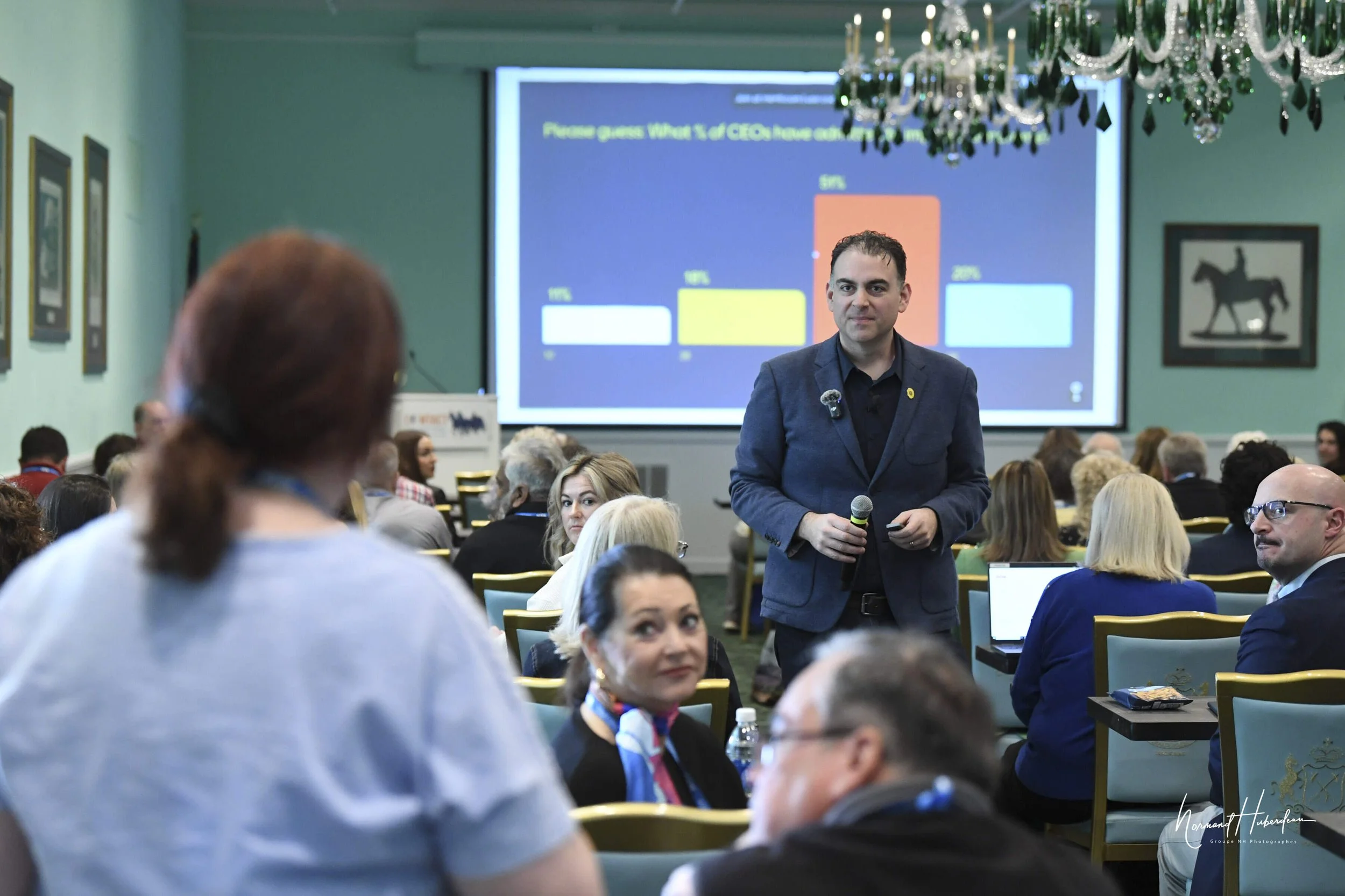 Man standing in audience.