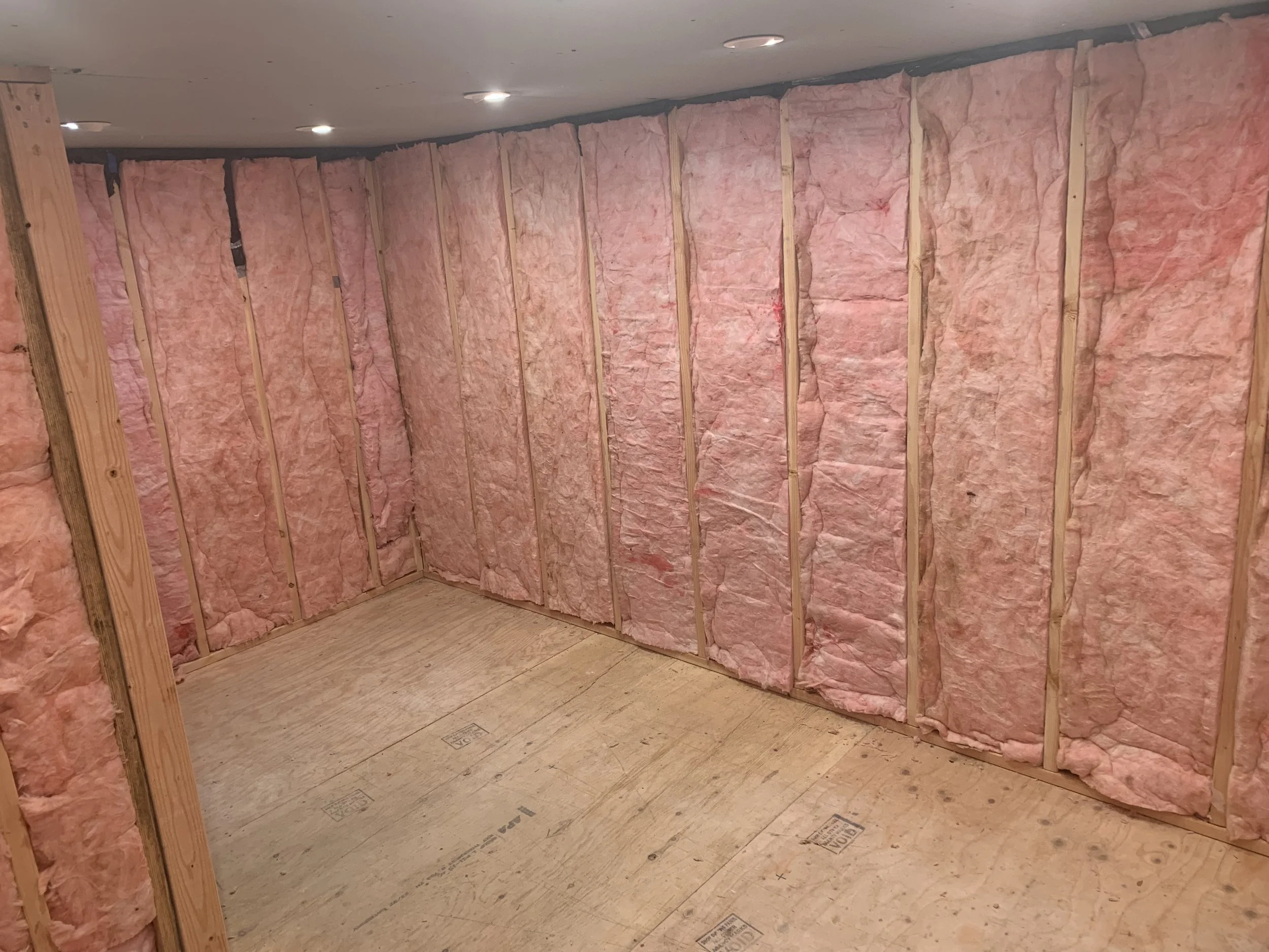Step 4: Frame room, run electric and lighting, and insulate (first install 6 mill vapor barrier behind the stud wall, use either 2x4 or 2x6 walls for greater efficiency)