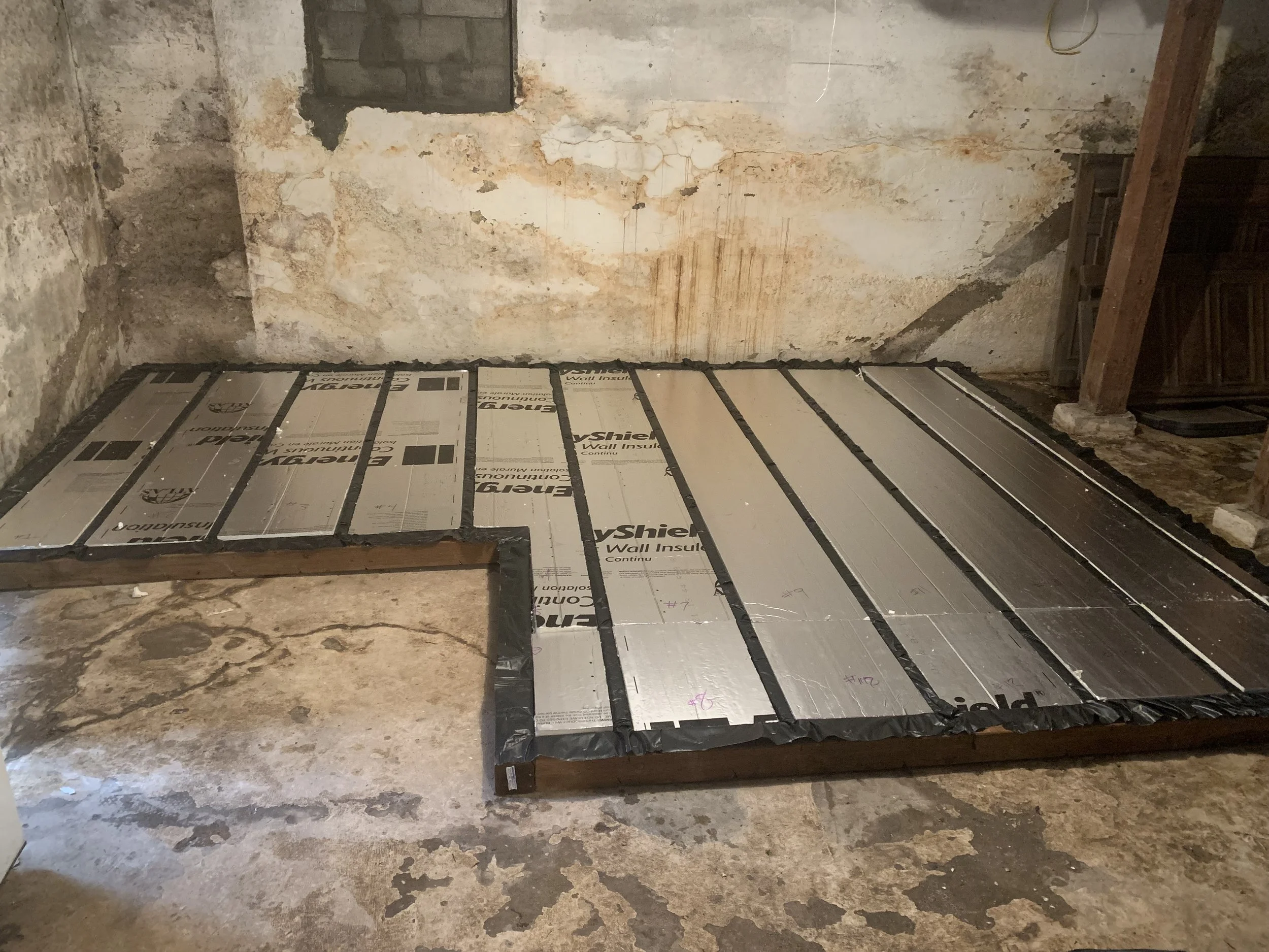 Step 2: Build an optional floor using 6mill vapor barrier, then stud grid, then fill with rigid insulation 