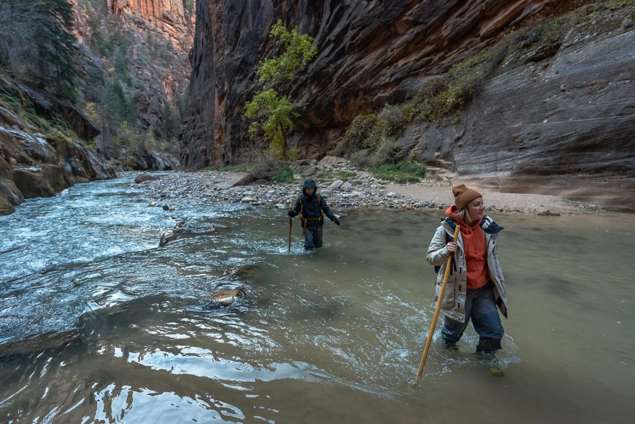 Narrow canyon walls surrounding the Virgin River in The Narrows Zion Utah
