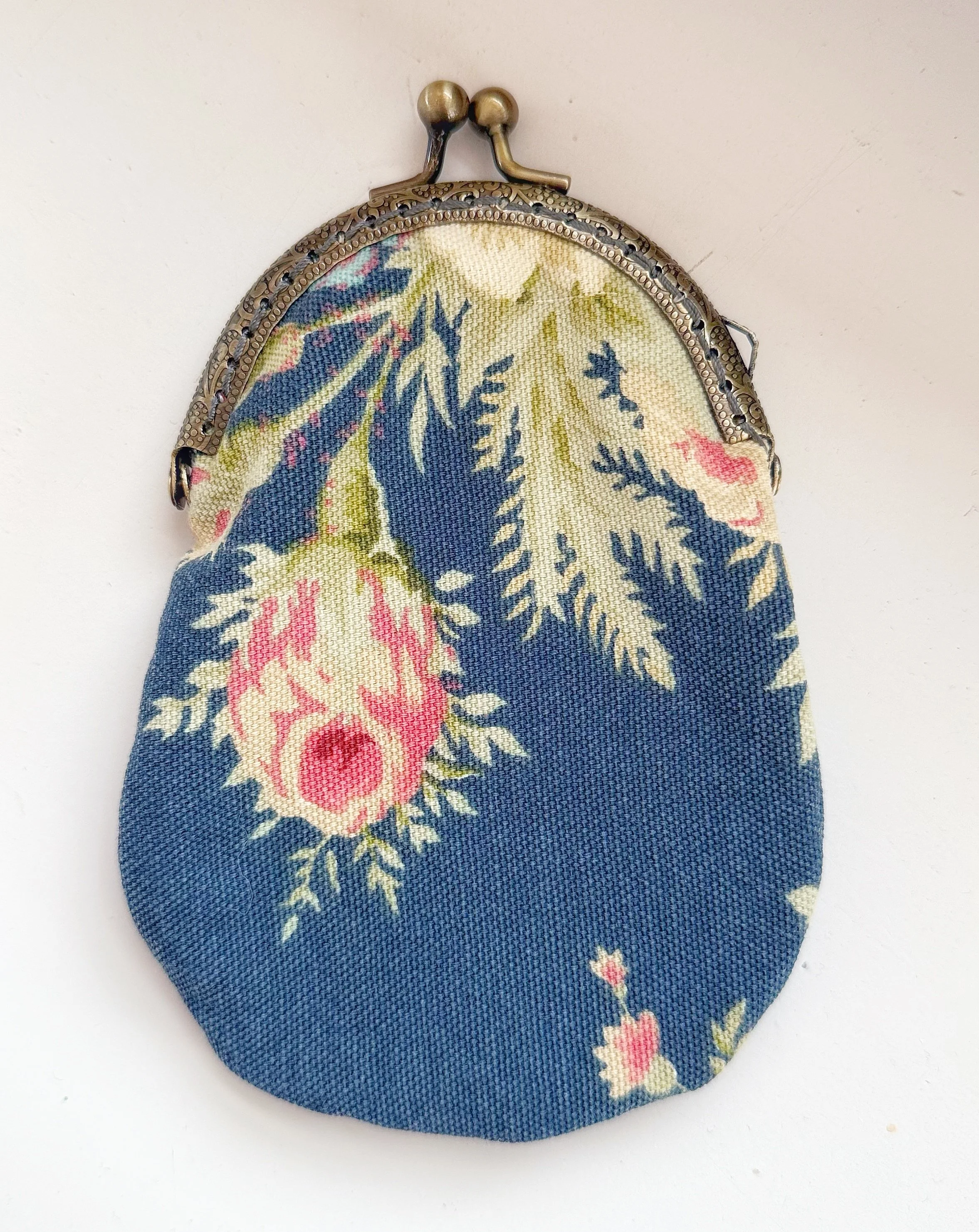 Vintage curtains, reimagined as a vintage change purse.
