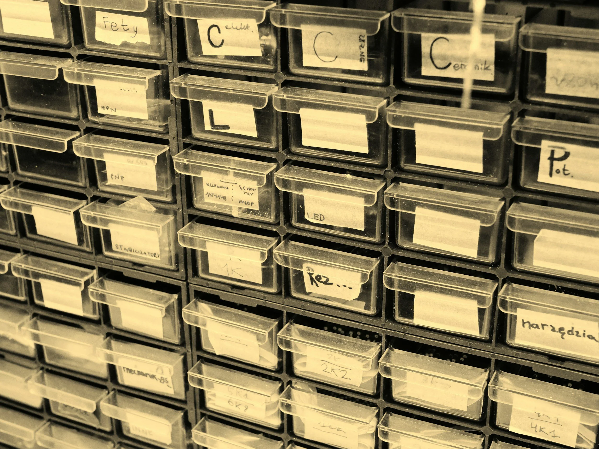 Organized storage bins with handwritten labels, providing an aesthetic representative of a digital database.