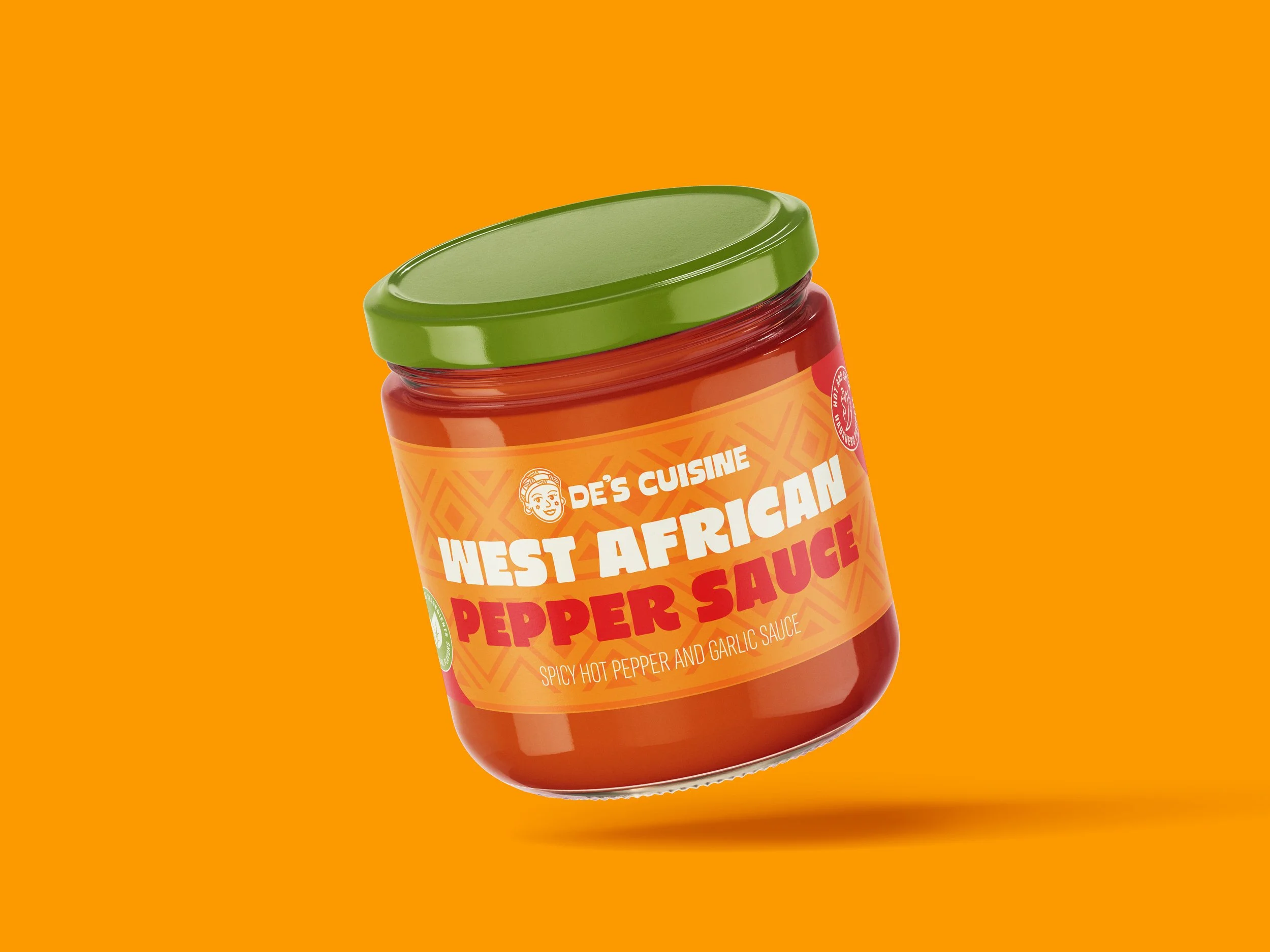 A jar of West African pepper sauce with a green lid and bright orange label, set against an orange background.