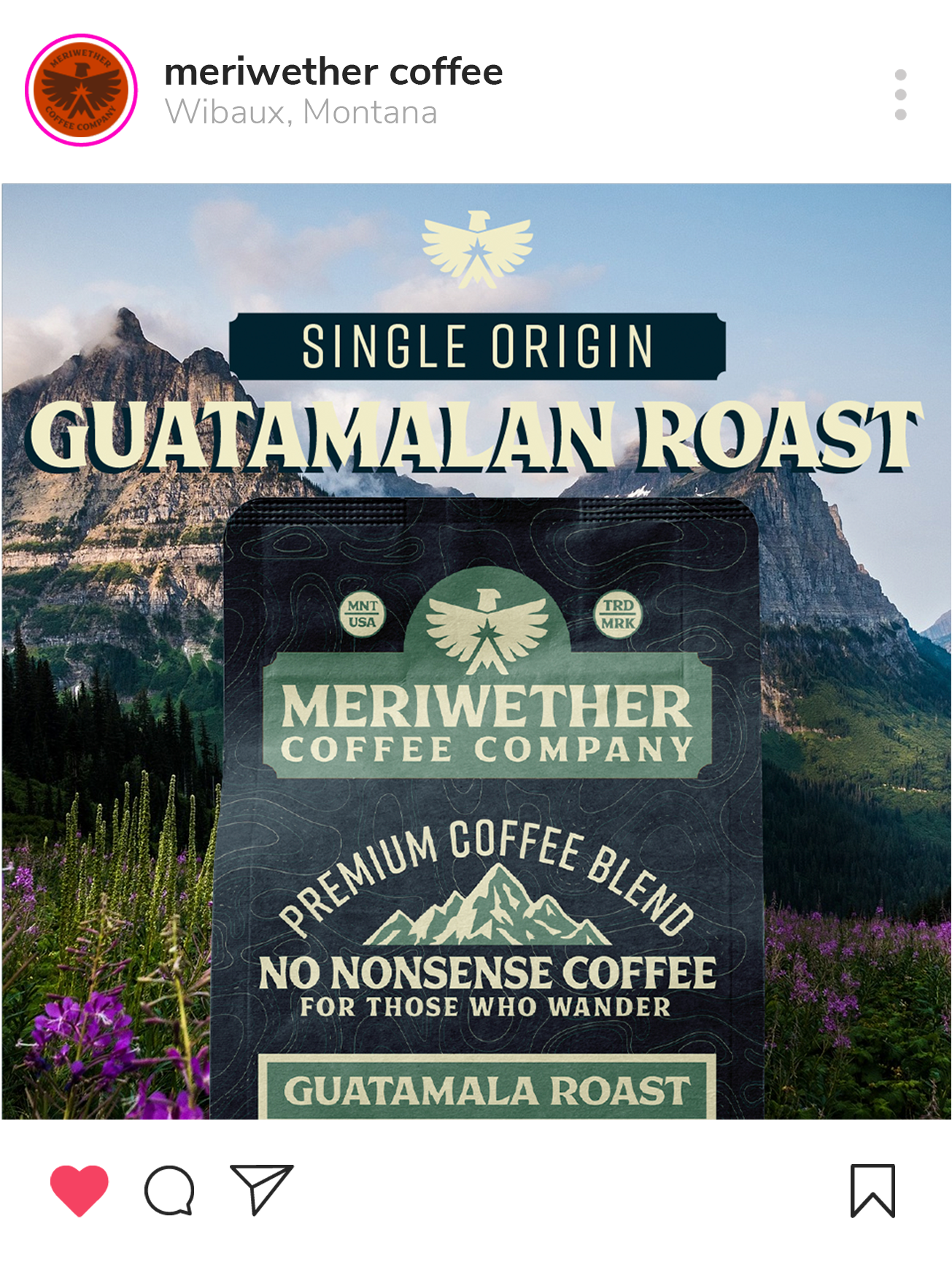 Packaging of Meriwether Coffee Company Guatemalan Roast, featuring a mountain landscape background with purple flowers, mountains, and a blue sky.