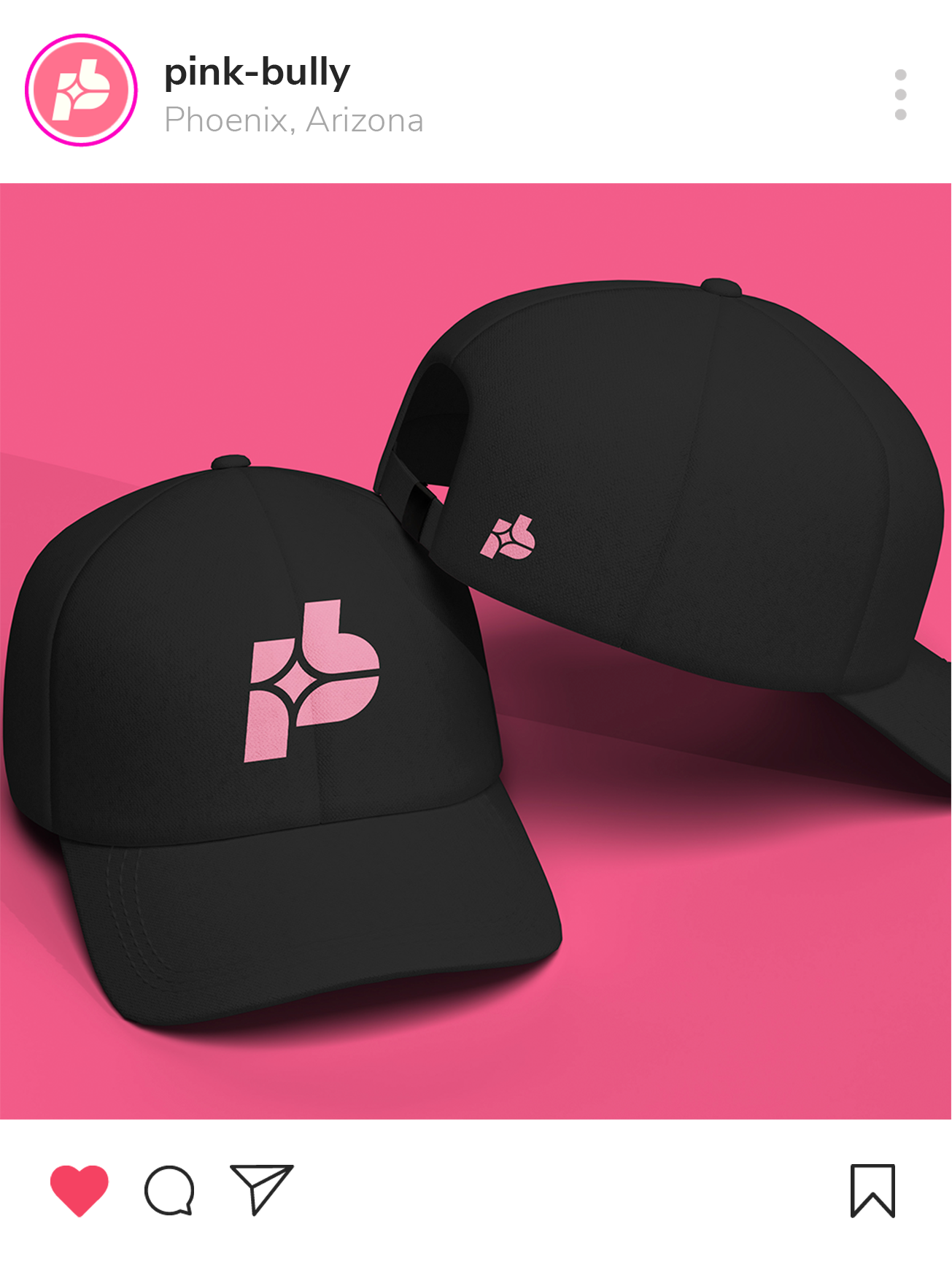 Two black baseball caps with pink logo on pink background.