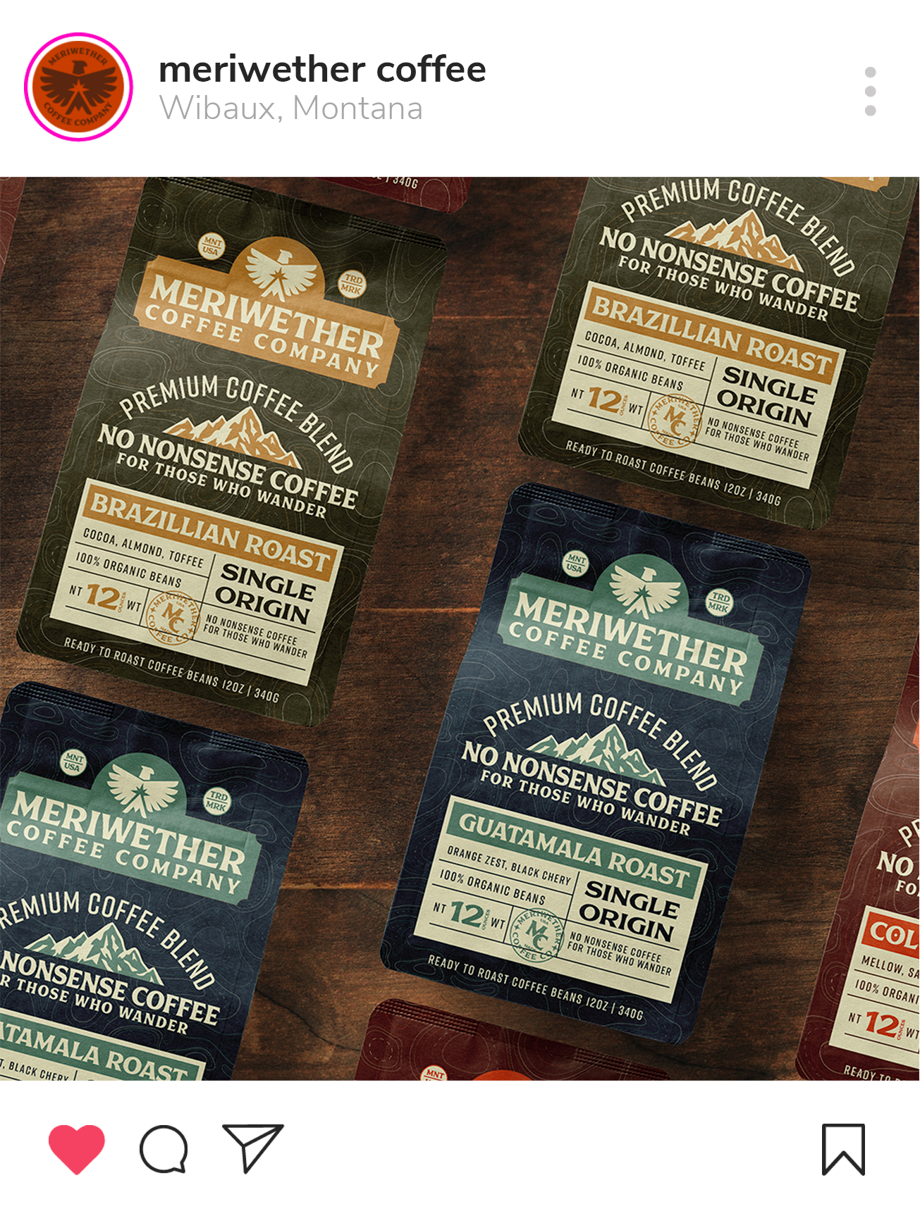 Close-up of three coffee bags from Meriwether Coffee Company, featuring Brazilan Roast and Guatamala Roast, on a wooden surface.