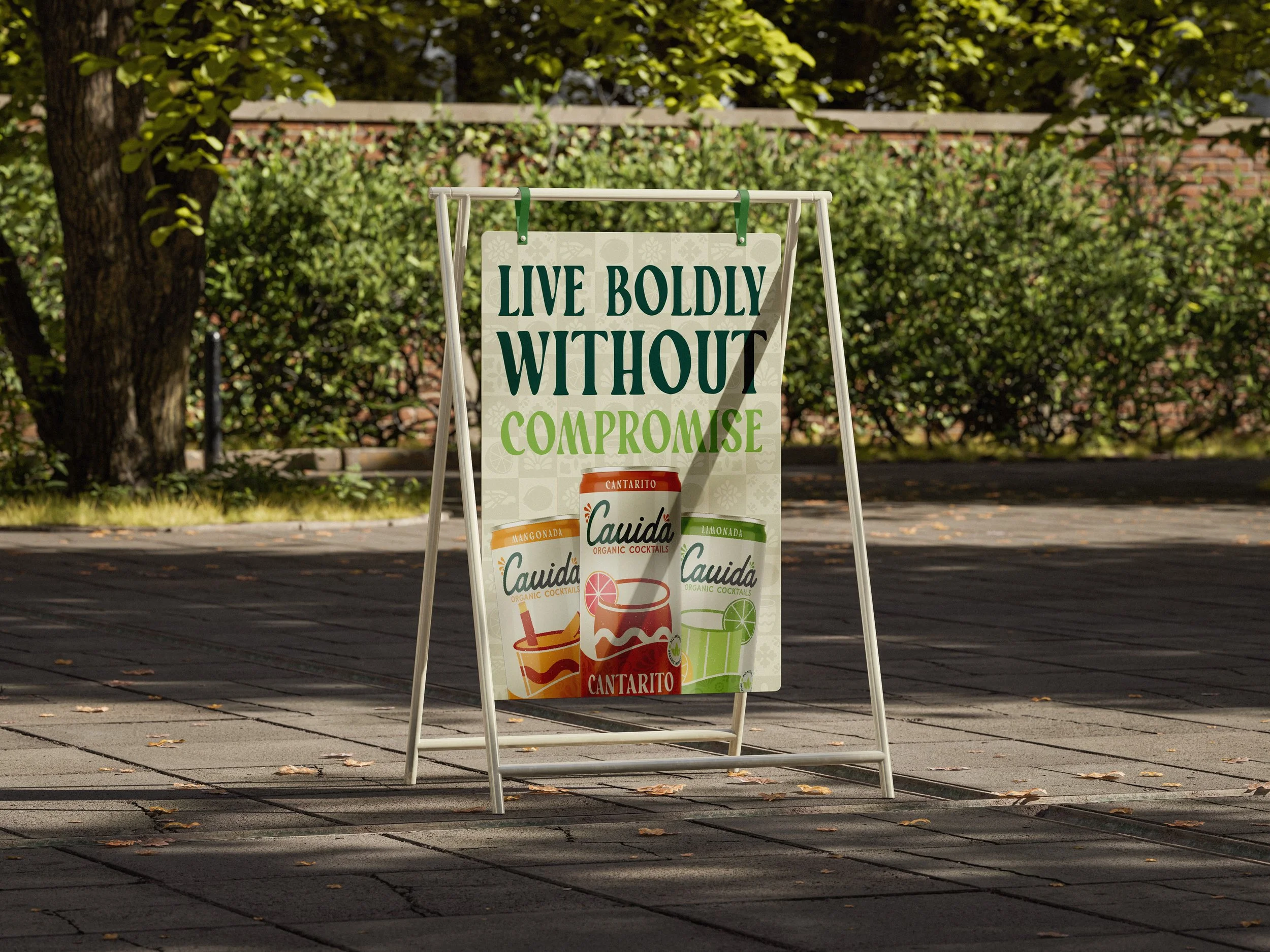 A sidewalk signboard with the message: 'Live boldly without compromise' and images of various Cauda organic cocktail cans, including Cantaro, Mango, and Lime flavors, displayed in an outdoor setting.