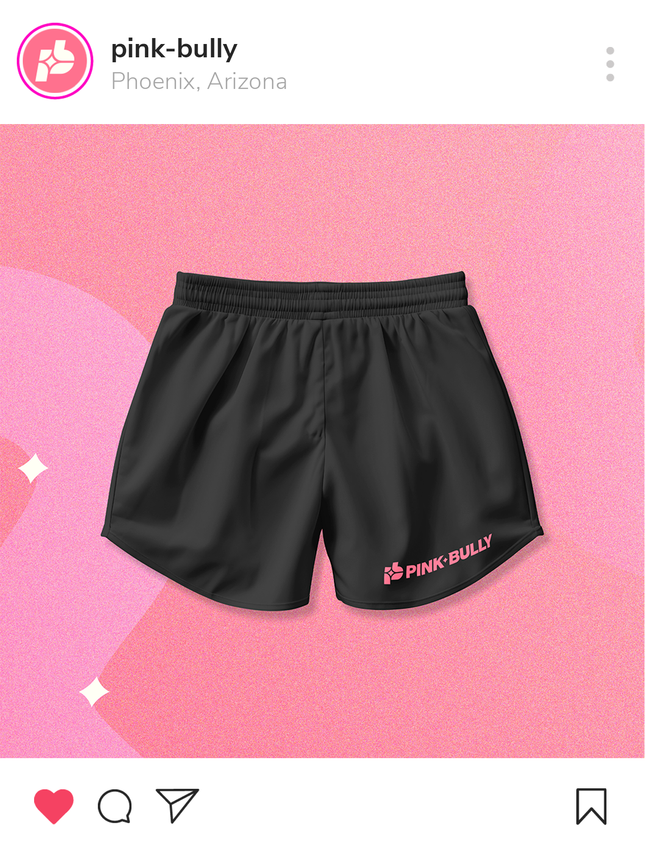 Black shorts with pink logo that says 'PINK BULLY' on the bottom right corner, set against a pink and peach background.