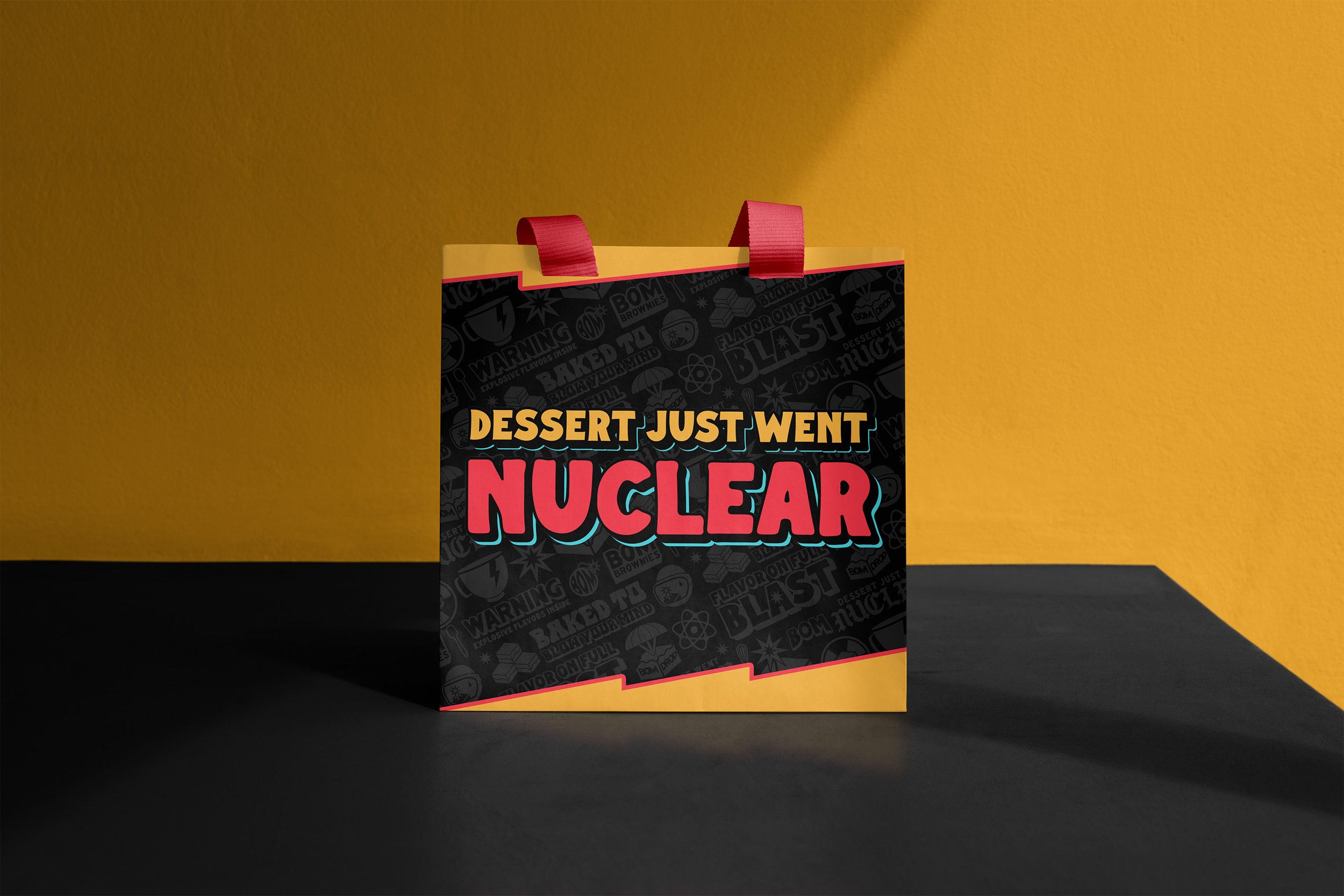 Colorful gift bag with the phrase 'Dessert just went nuclear' on a yellow and black background.