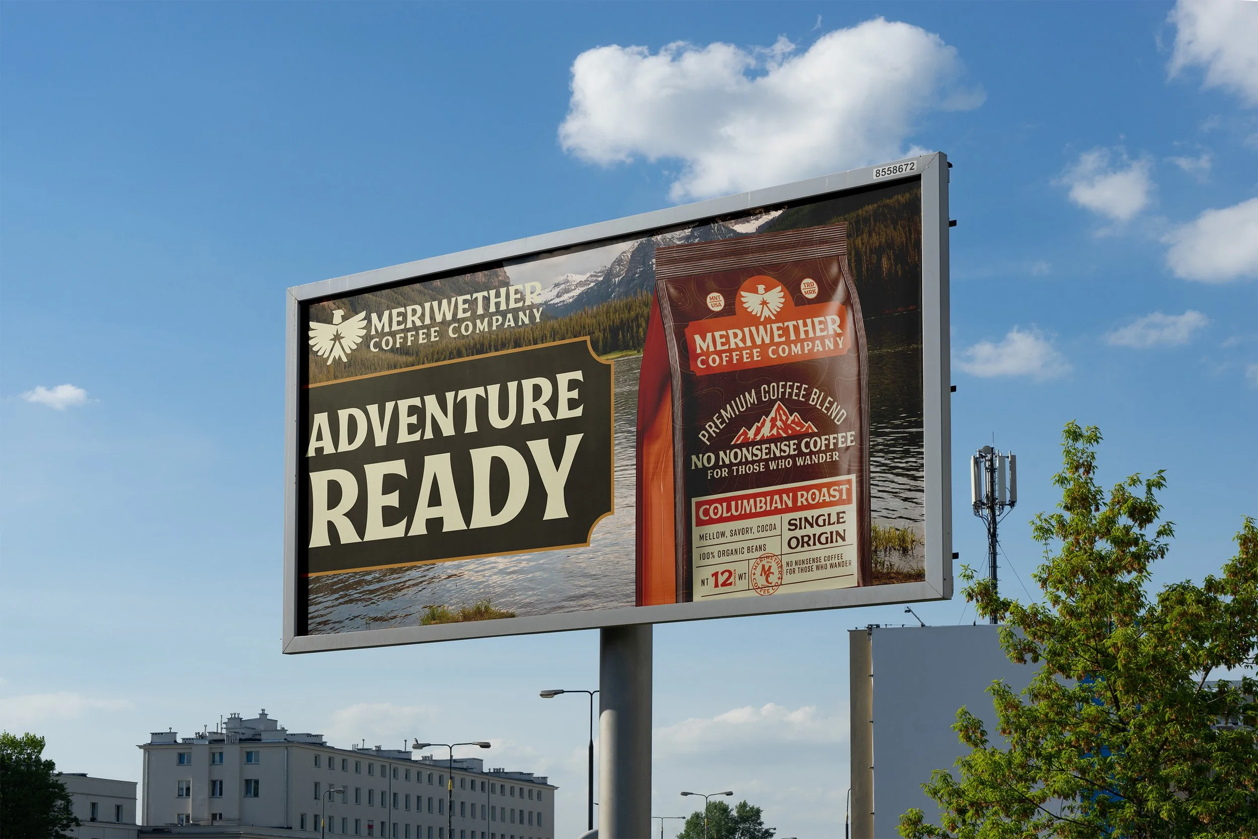 Advertisement billboard for Meriwether Coffee Company featuring a mountain lake scene and a bag of Columbian roast coffee with the words 'Adventure Ready' and details about the coffee.