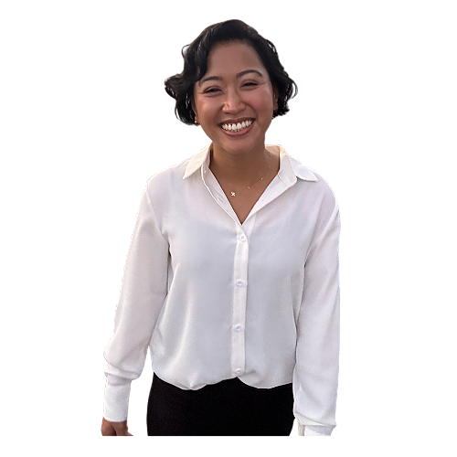 Helen Bass - Smiling woman with short dark hair wearing a white button-up shirt and black pants, standing against a plain background.