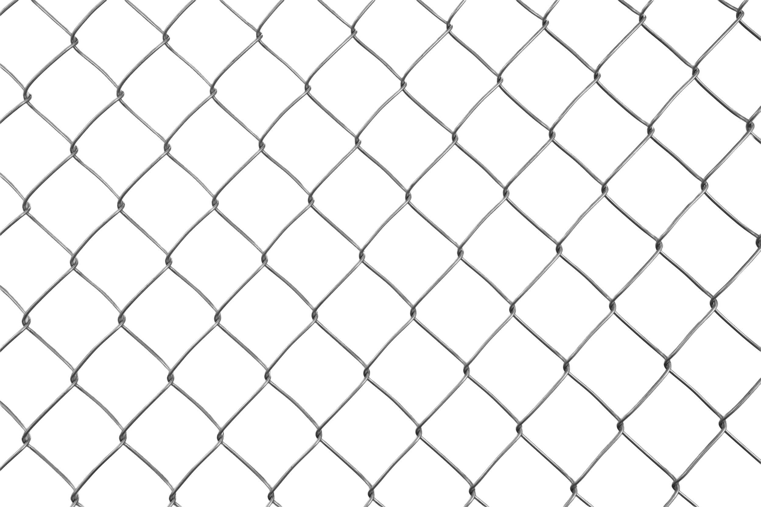 Close-up of a chain-link fence with a black background.