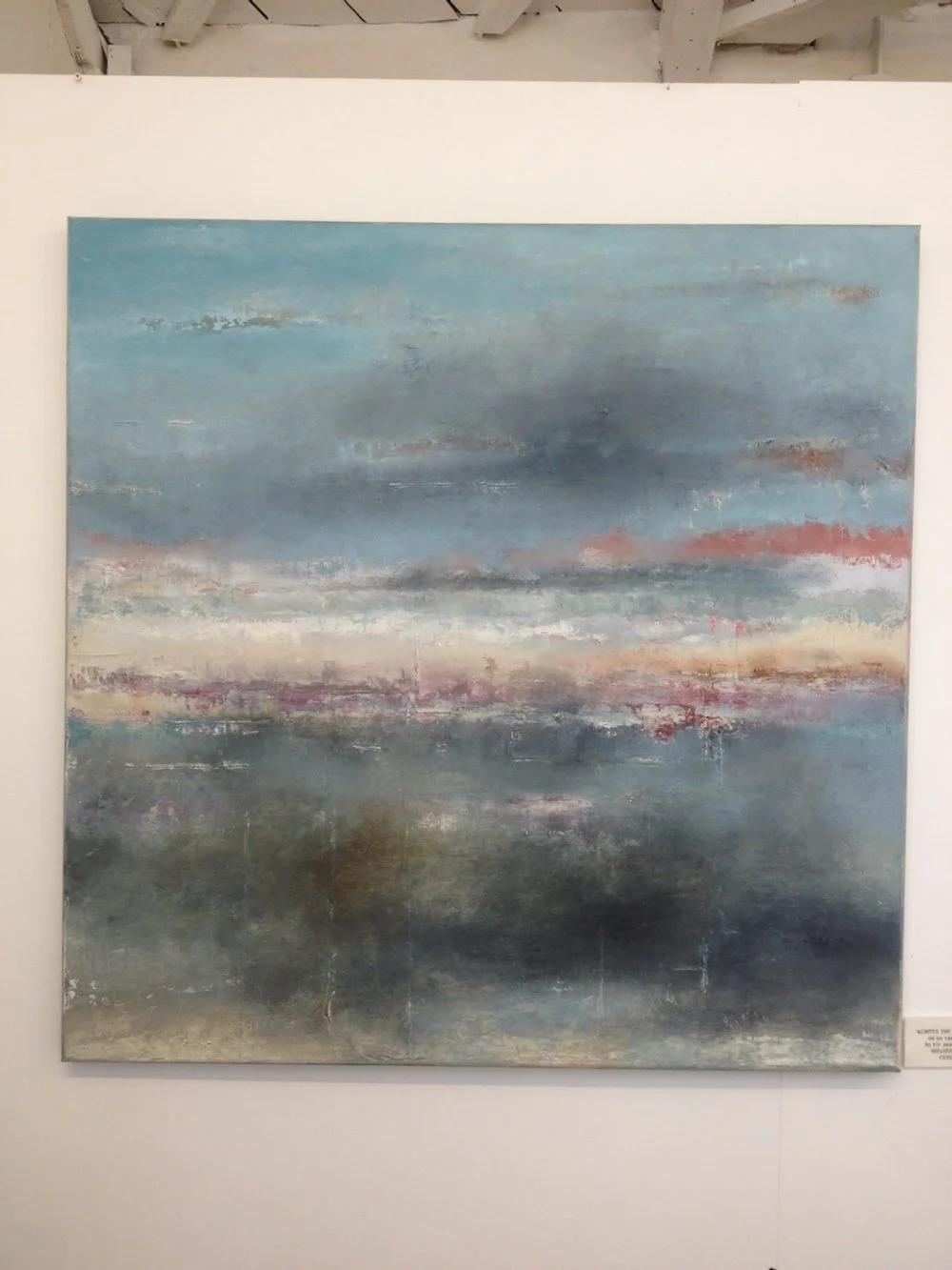 Abstract landscape painting depicting a sunset over a body of water with a blend of blue, pink, and gray colors.