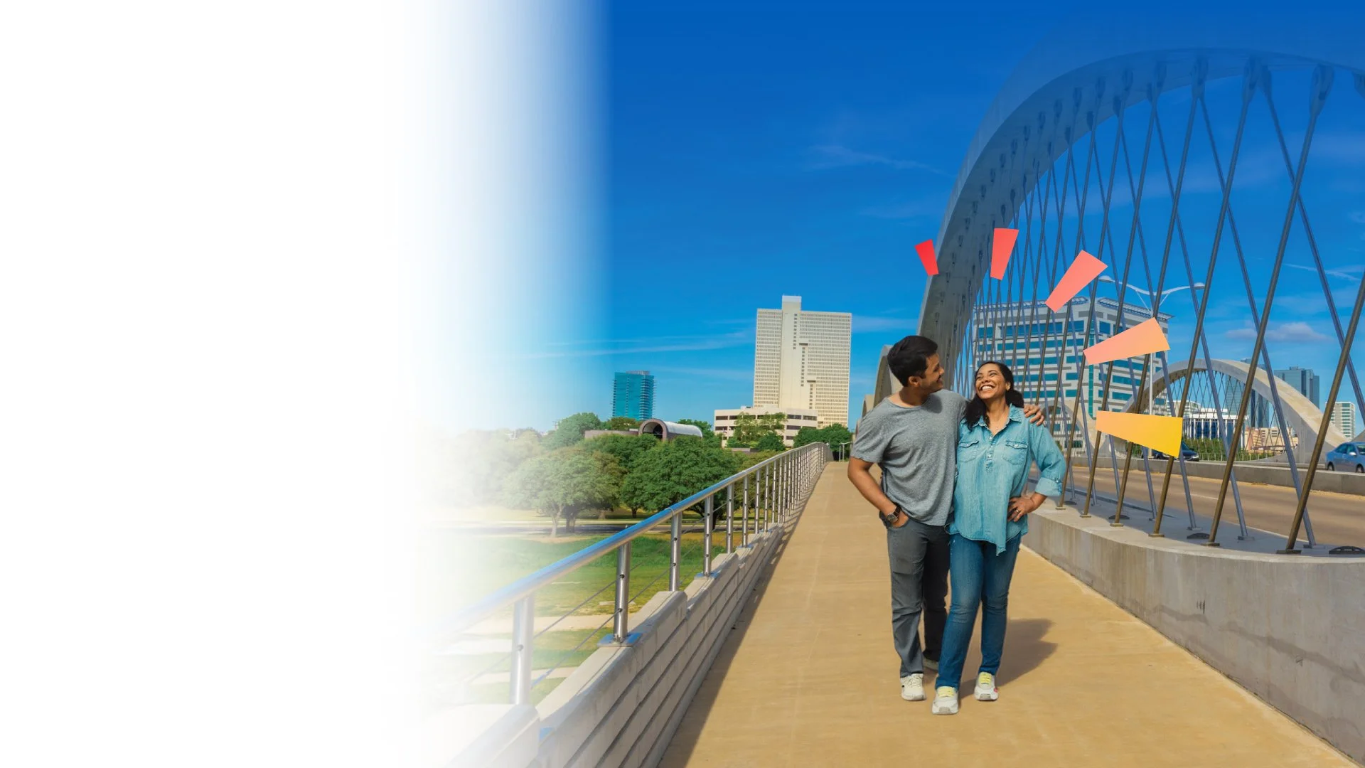 couple walking on bridge smiling