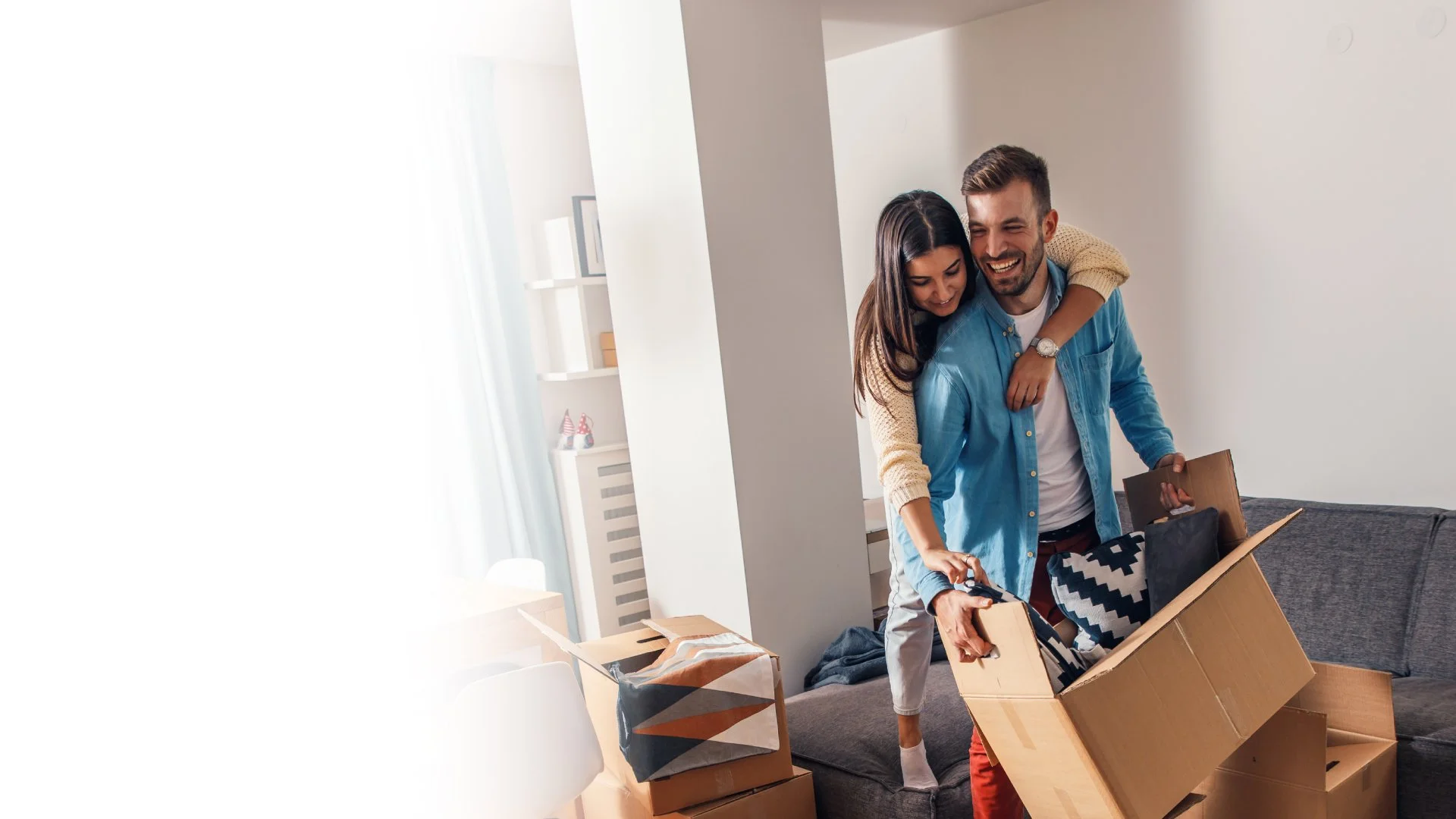 Couple hugging moving furniture