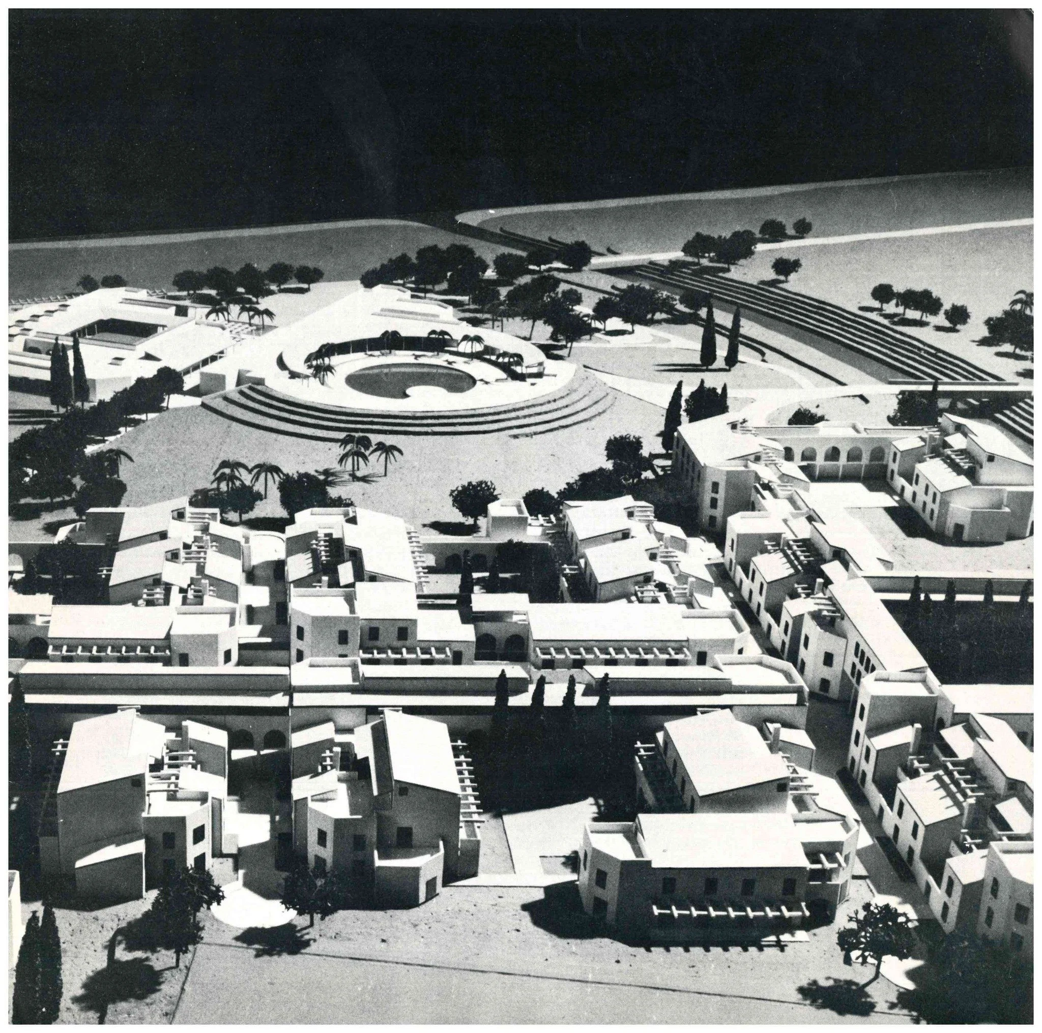 Black and white model of a modern residential community with multi-story buildings, trees, pathways, and a circular open space with steps.