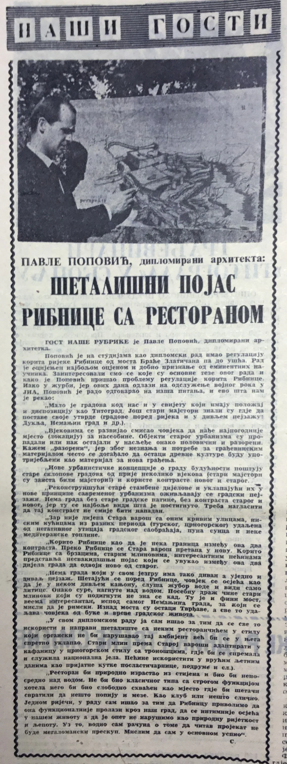 Black and white newspaper clipping with a photo of a man in a suit working on a model of a river with a restaurant.