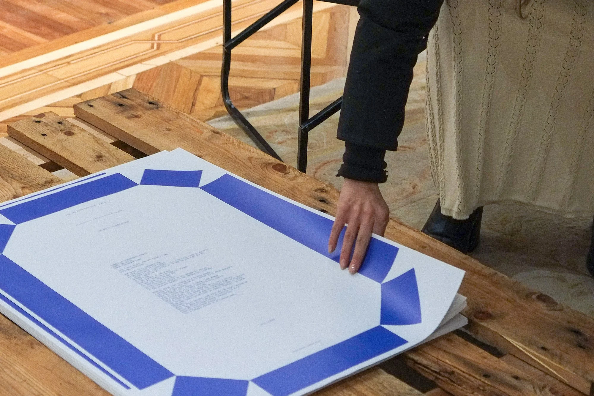 Photo of a woman picking up one of the posters