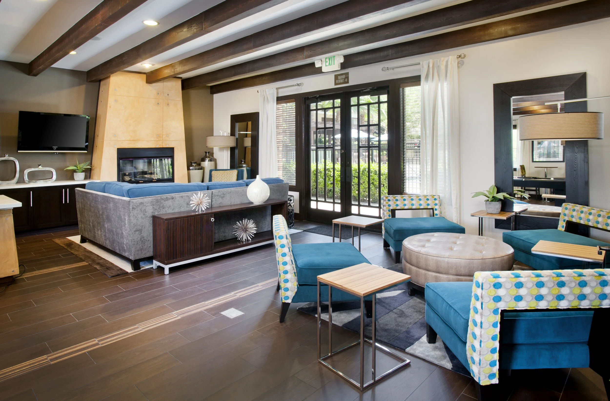 Interior of the Clubhouse at The Overlook at Rancho Belago with sitting area, couch, fireplace, and windows looking out onto the beautiful property.