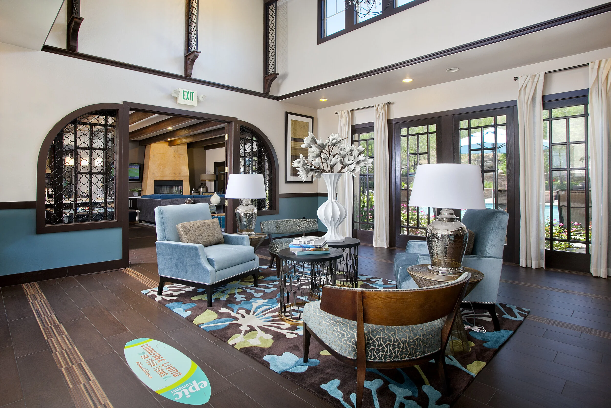 Interior of the clubhouse at The Overlook at Rancho Belago with sitting area, vaulted ceilings, and large windows.