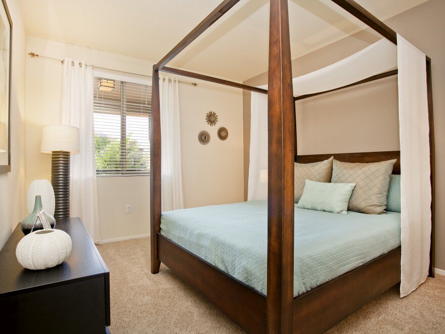 Bedroom at The Overlook at Rancho Belago with carpeted flooring, cream walls, and large window.