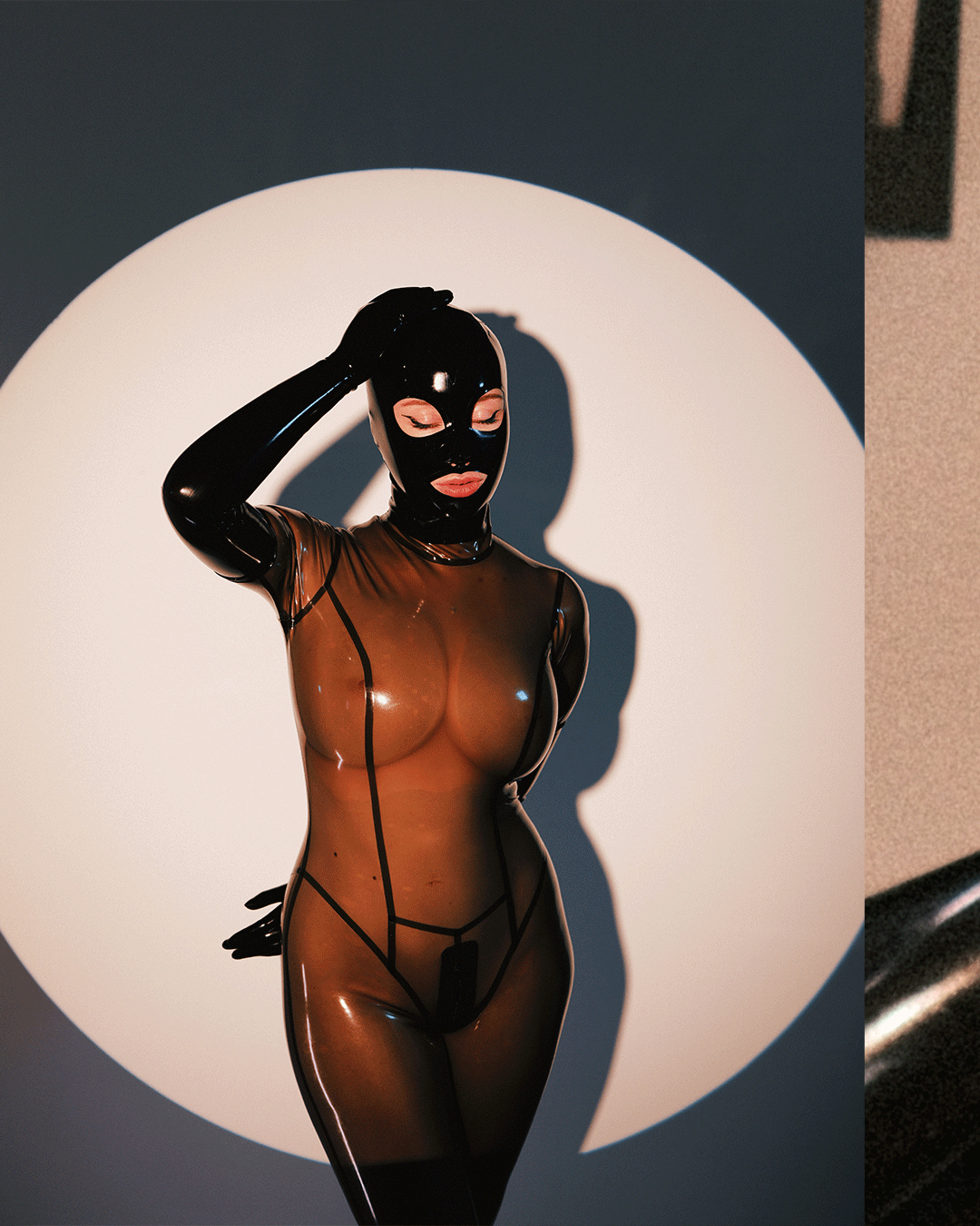 MarieOnCamera-SmokeyBlackTransparentLatexCatsuit-Carousel1_03.gif