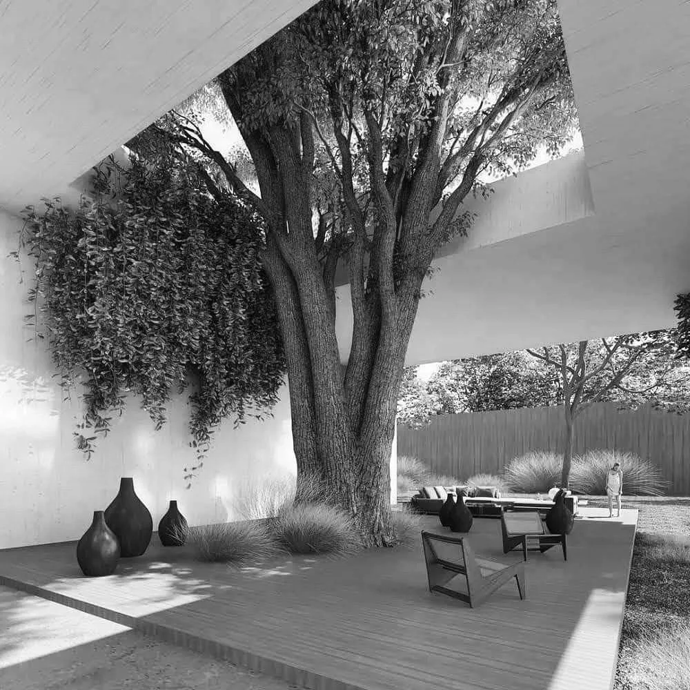 Modern outdoor patio with a large tree, potted vases, outdoor chairs, and a person standing near bushes in the background.