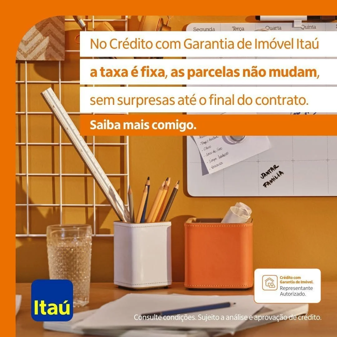 Imagem de um escritório com objetos de escrita, como canetas e lápis em um porta-canetas, uma garrafa de água, papéis, quadros brancos e avisos na parede. Uma mensagem promocional do banco Itaú sobre crédito com garantia de imóvel, destacando que a t