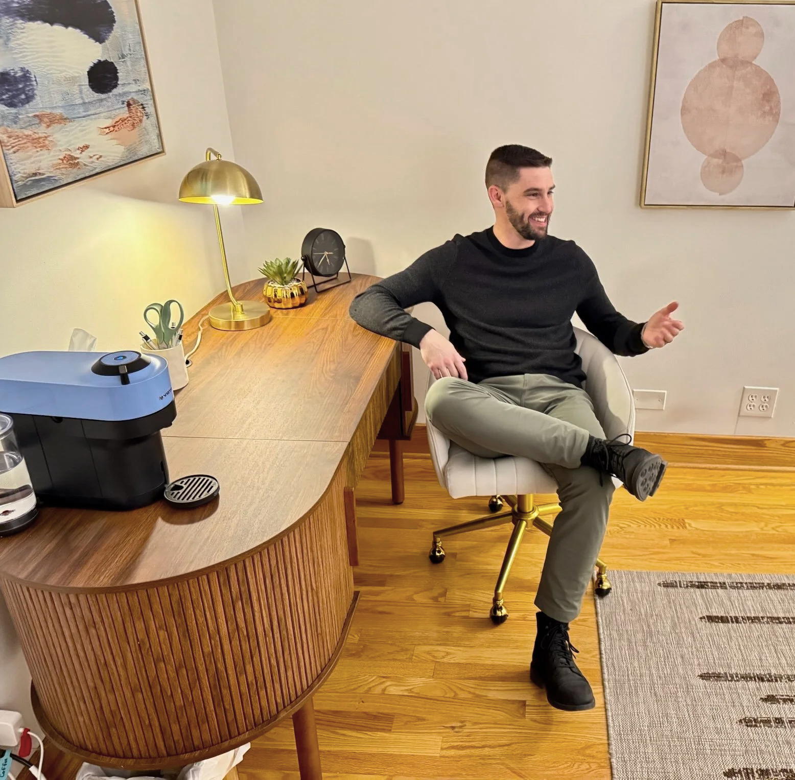man sitting at desk smiling