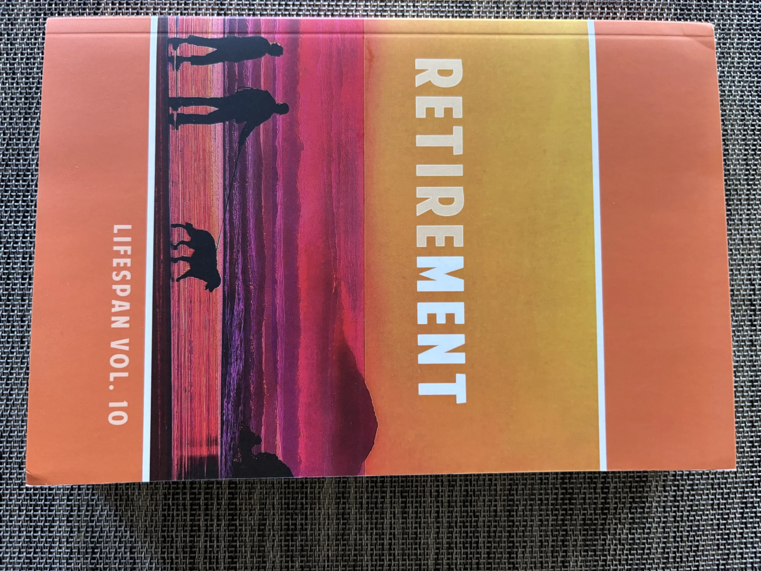 Book cover titled "Retirement" by LifeSpan Voi. Features a silhouette of two people walking dogs by a colorful sunset over water.