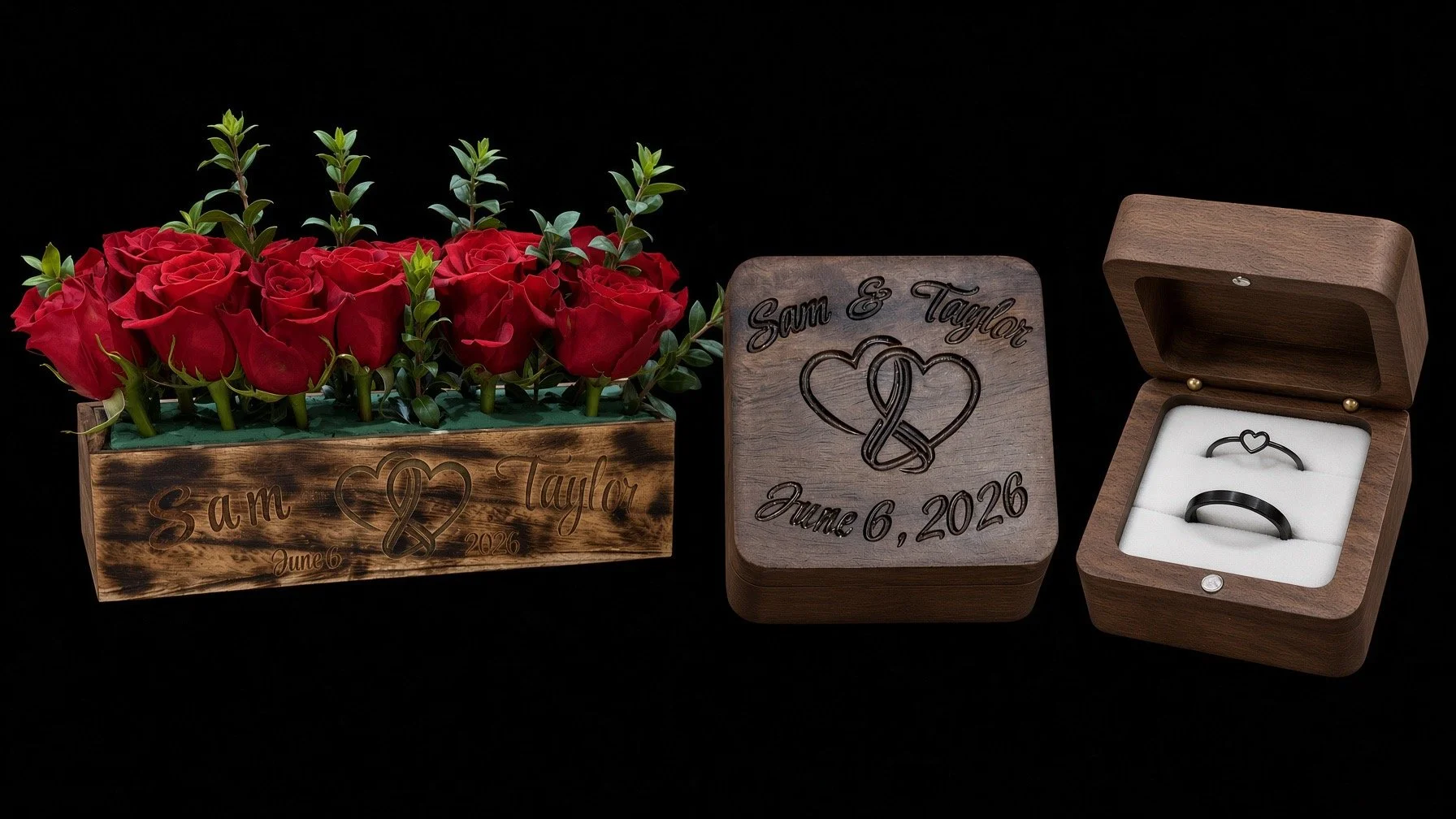 A wooden box with red roses and green leaves, engraved with 'Sam & Taylor, June 6, 2026'. A matching wooden keepsake with the same engraving, and an open wooden ring box displaying two black rings with engraved heart symbols.
