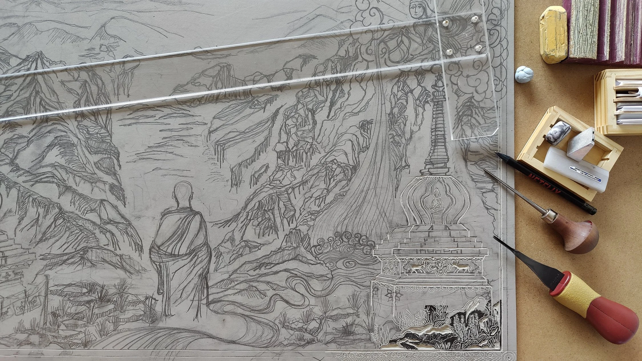 Esquisse d'une scène de paysage religieux avec un moine ou une figure spirituelle, une montagne, un temple avec une tour stylisée et une figure assise au centre, des éléments décoratifs et des outils de dessin autour.